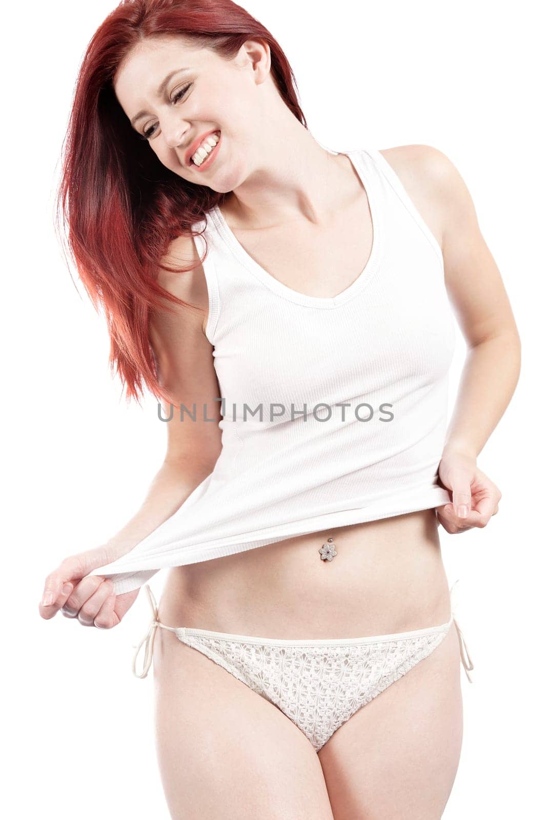 Attractive woman in white bikini bottoms and vest top posing