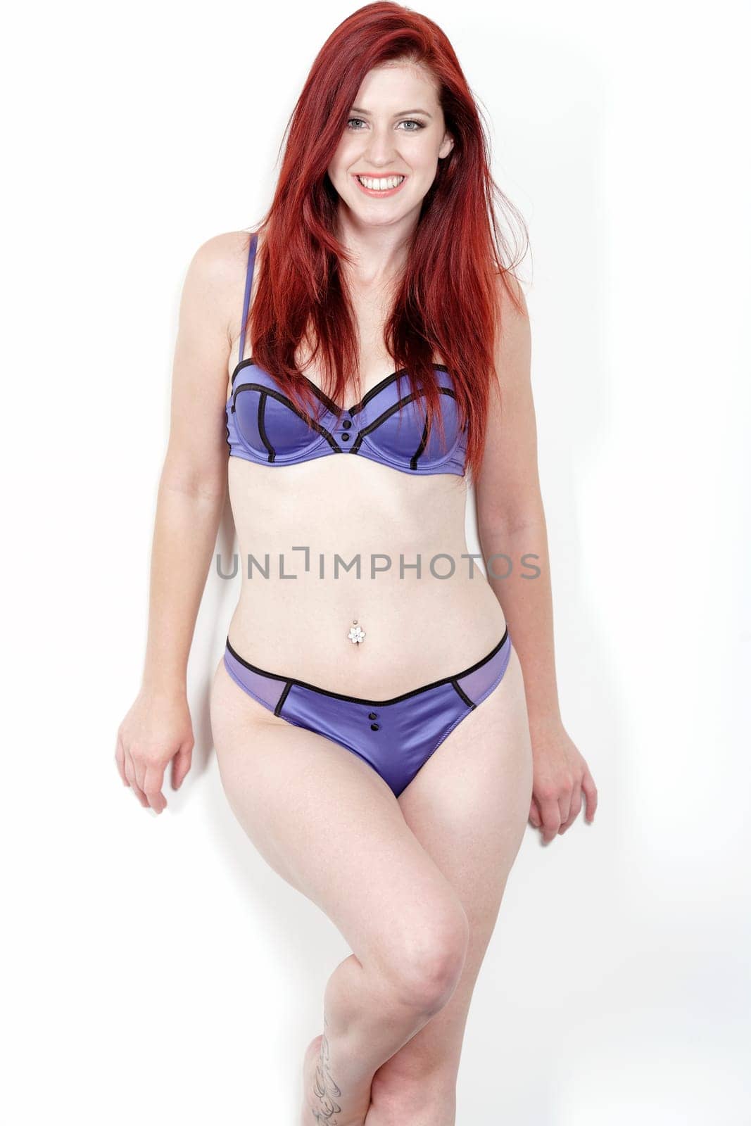 Attractive young woman in her underwear posing and having fun
