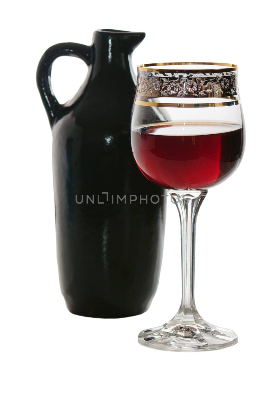Black jug for wine and a glass of red wine
