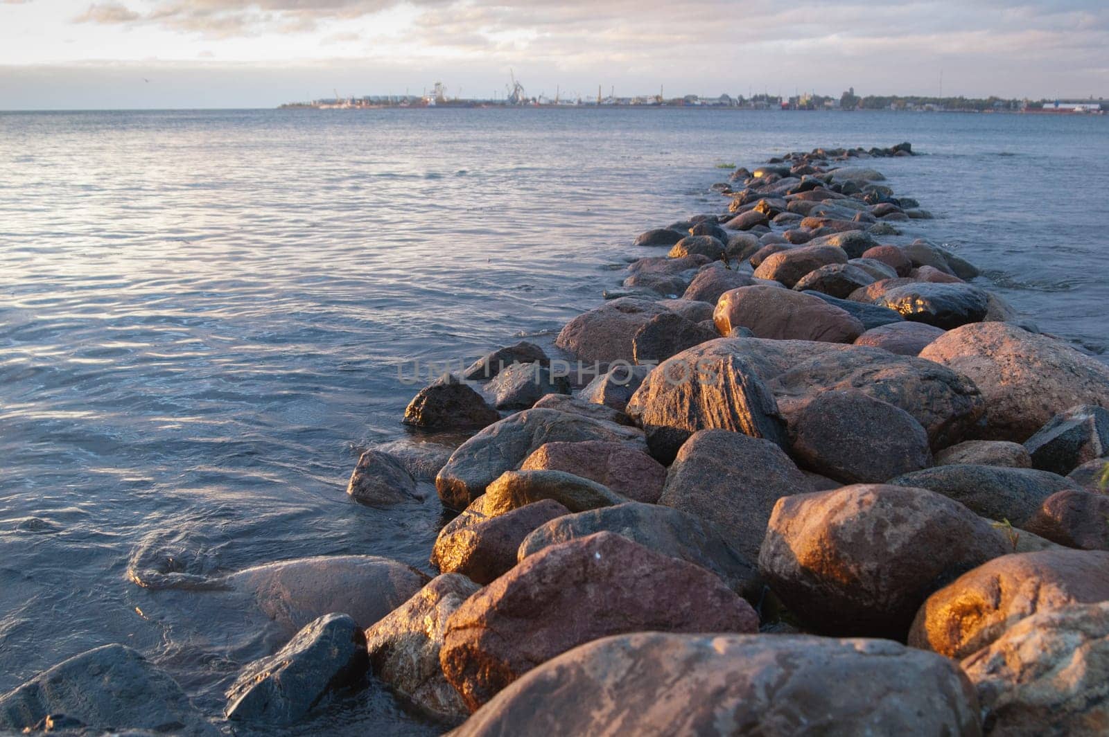 Pier from stones on a sunset