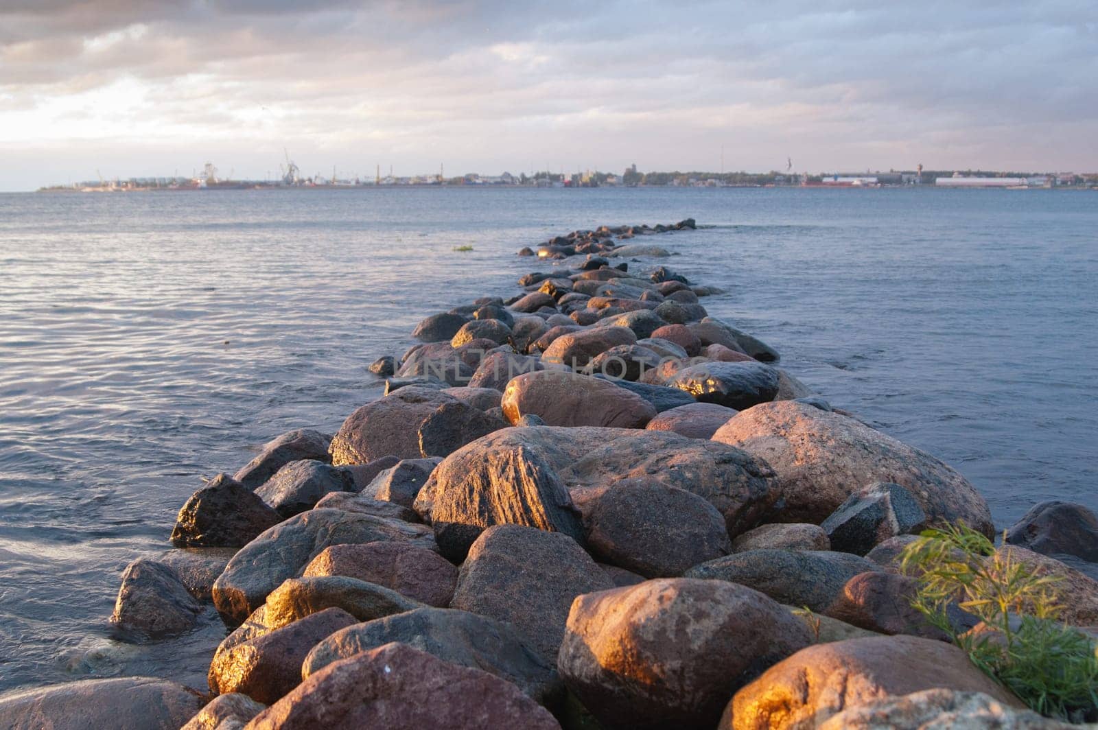 Pier from stones on a sunset