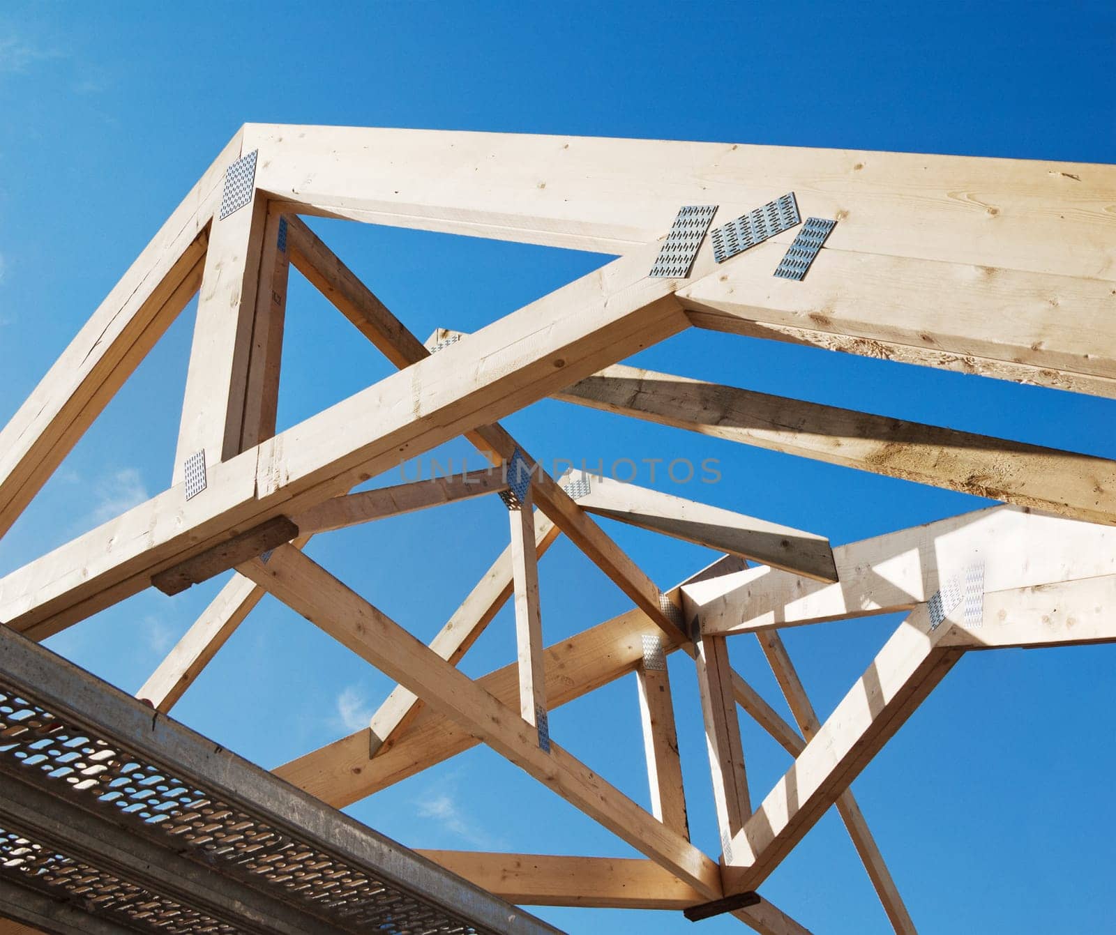Wooden rafters against the blue sky
