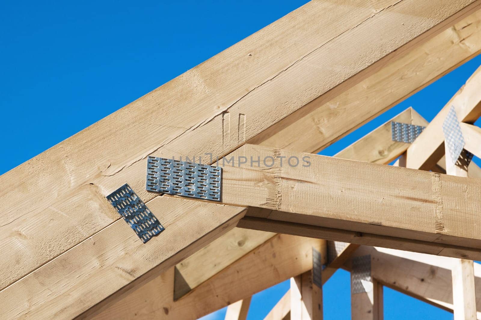 Wooden rafters against the blue sky