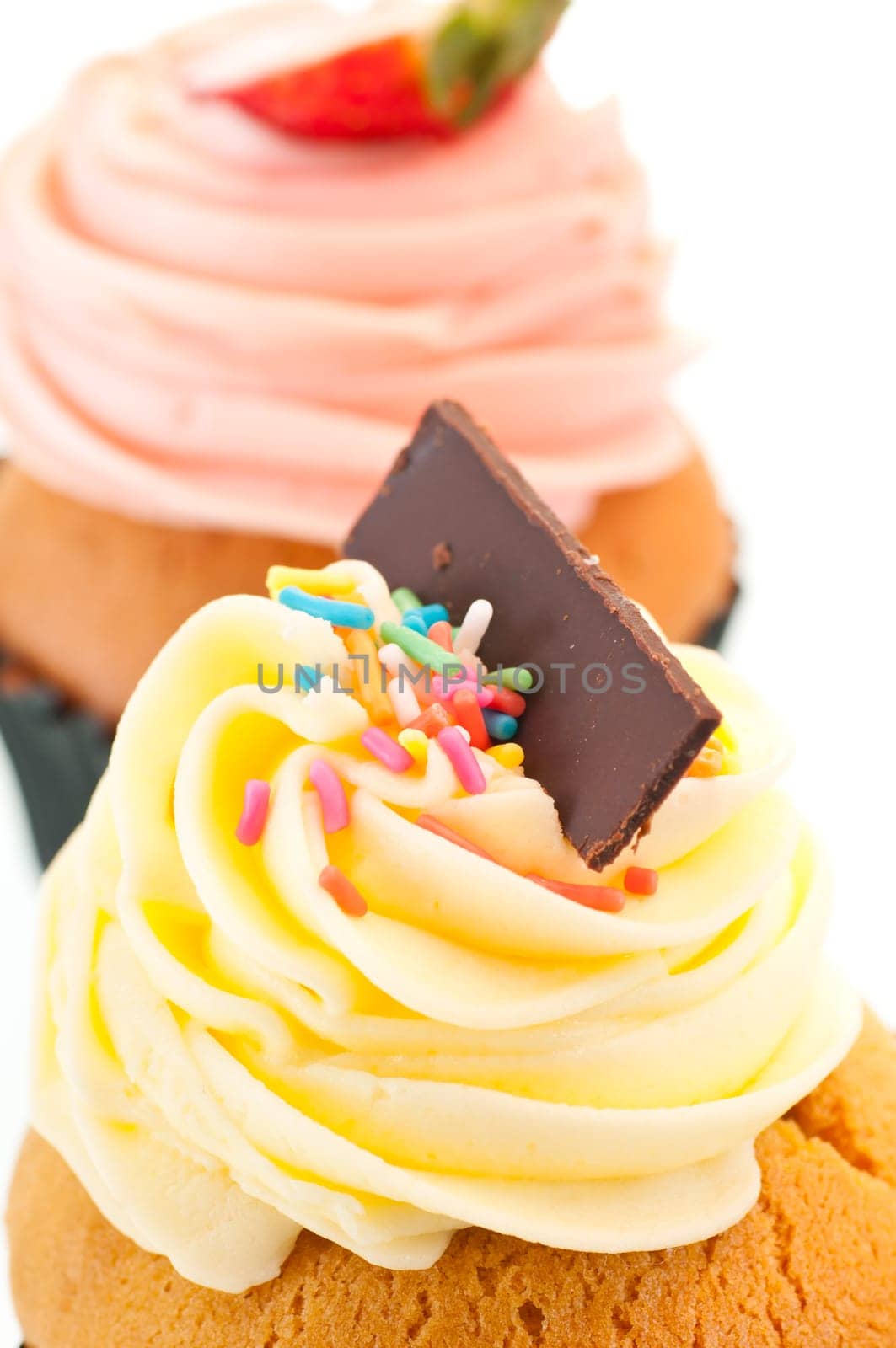 Vanilla cupcake topping vertical close up over white