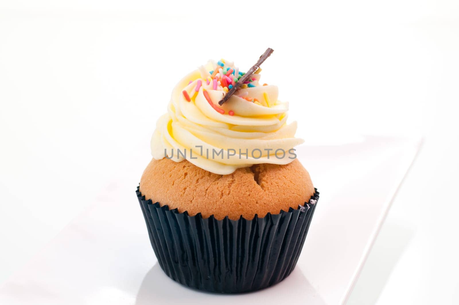 Vanilla cupcake close up on a white plate