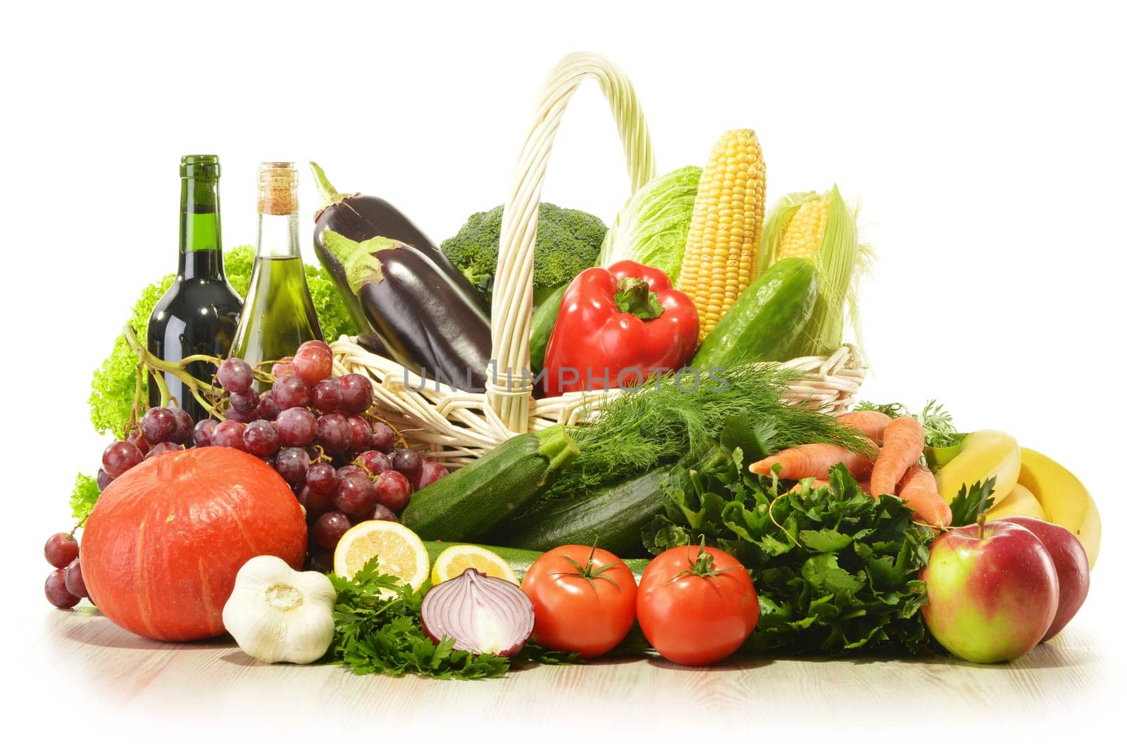 Fruits and vegetables in wicker basket isolated on white