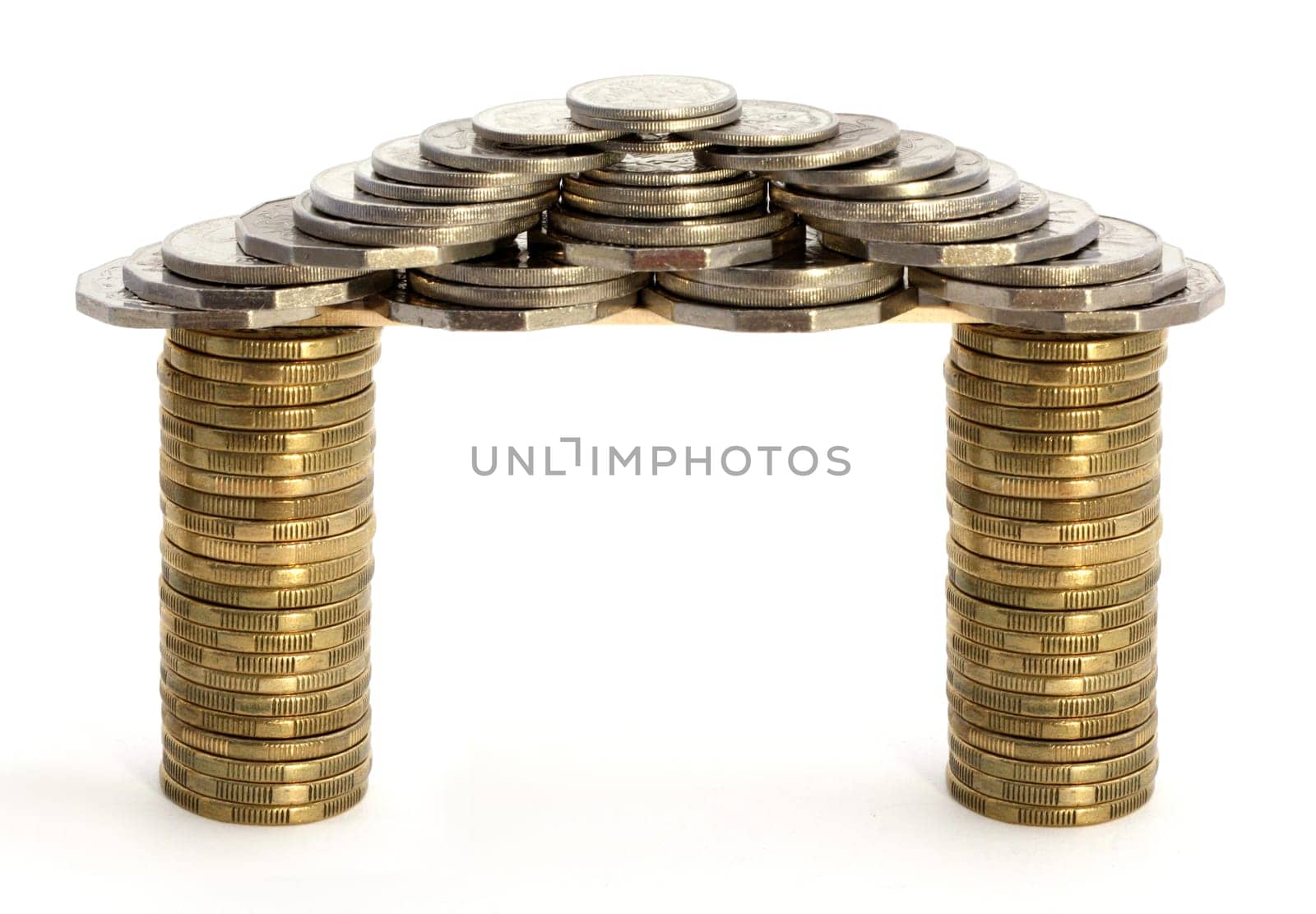House or gateway made of coins over white background. Concepts of wealth, riches, dream house, investment.