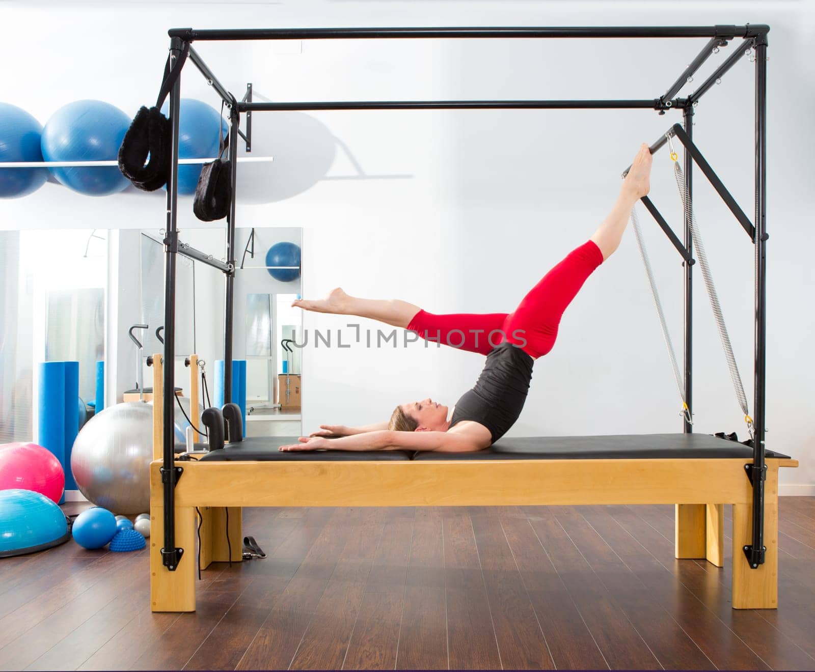 Aerobics pilates instructor woman in cadillac fitness exercise