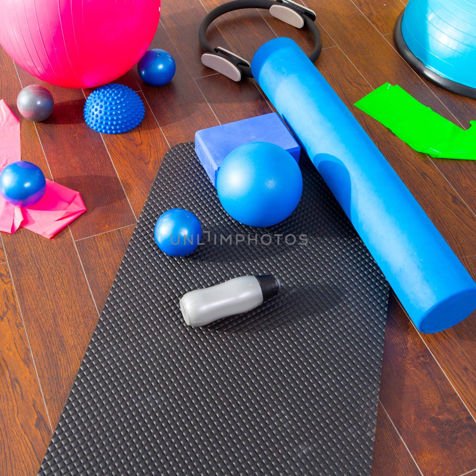 Aerobic Pilates stuff like mat balls roller magic ring rubber bands on wooden floor