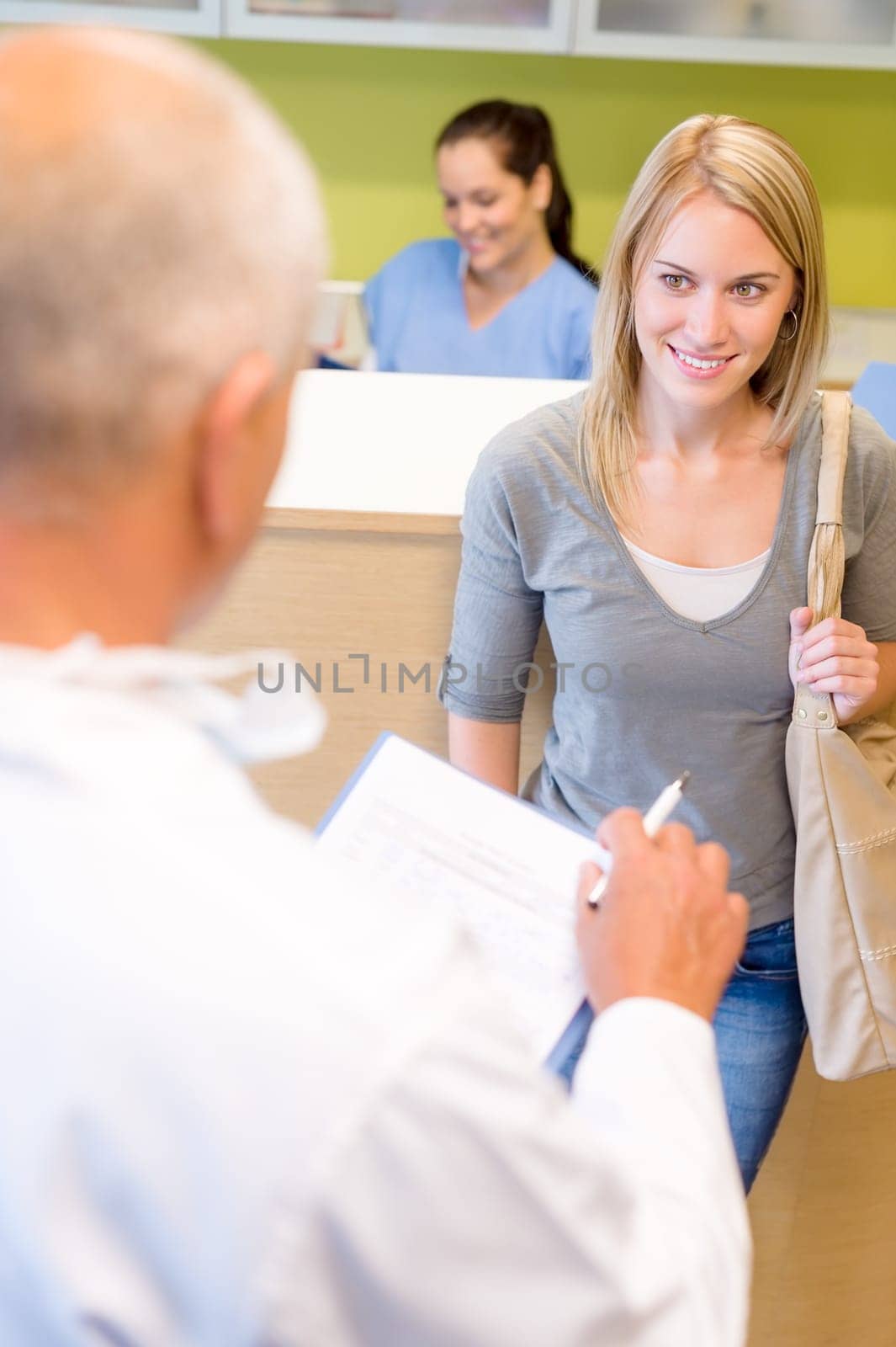 Male dentist calling next patient appointment for dental checkup