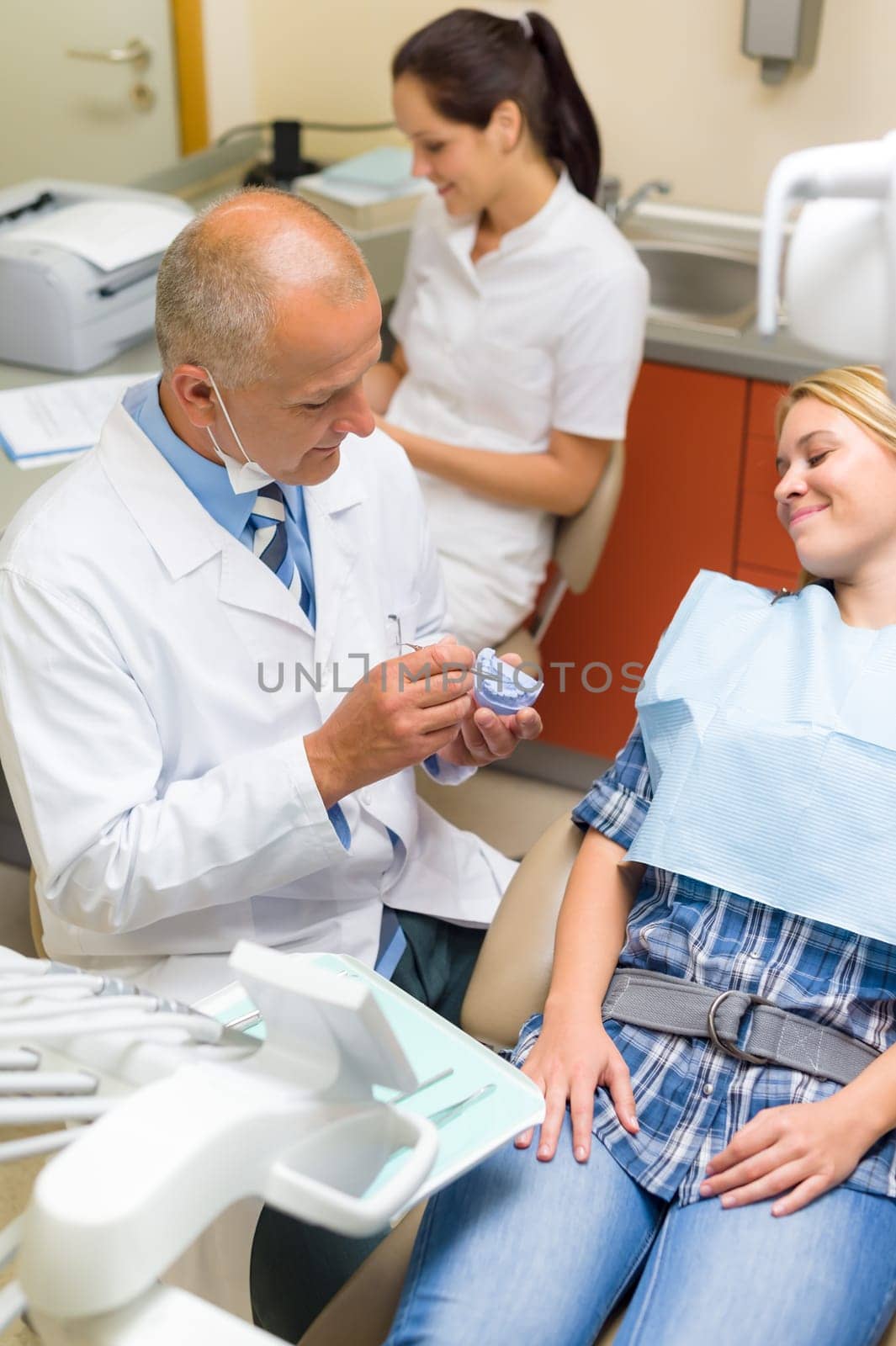 Visit at dentist showing female patient model of teeth