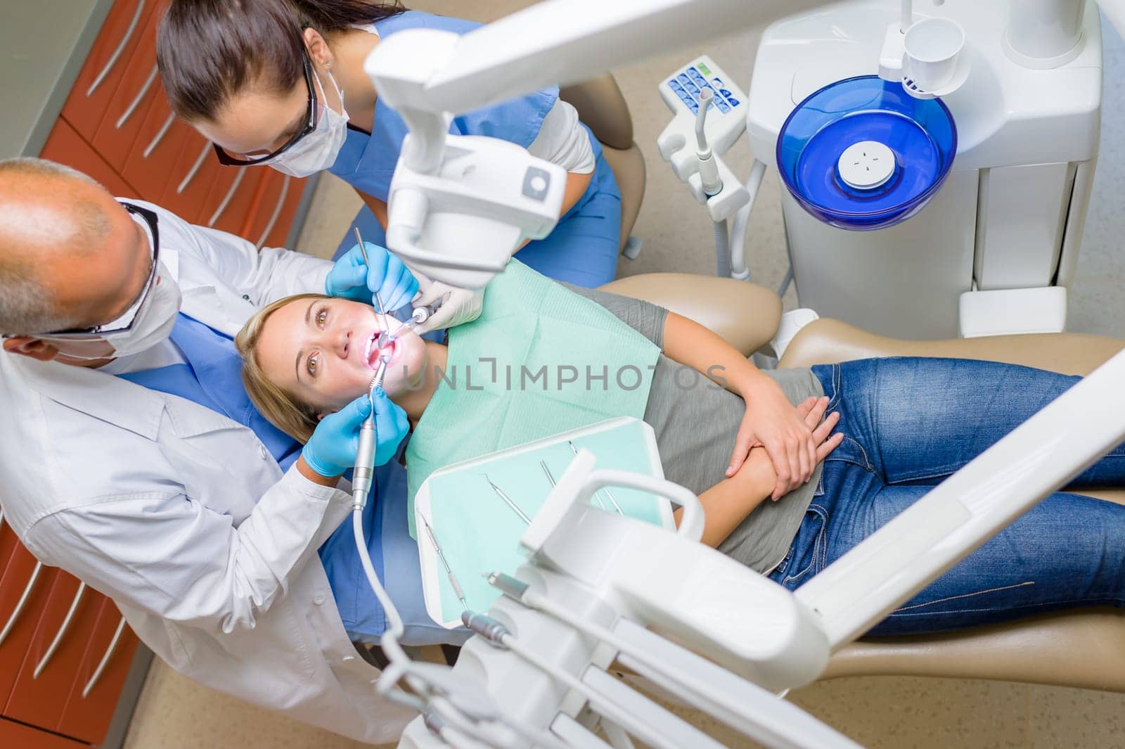 At the dentist young woman patient lying on dental chair