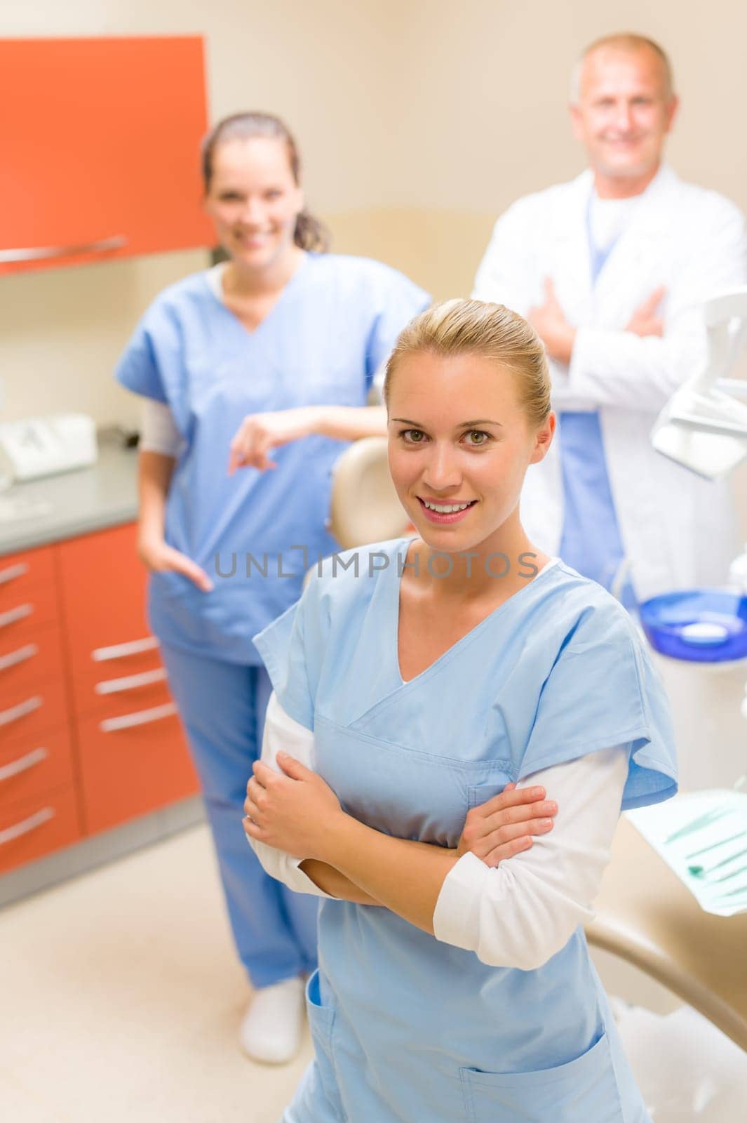 Portrait of dental team female dentist with colleagues