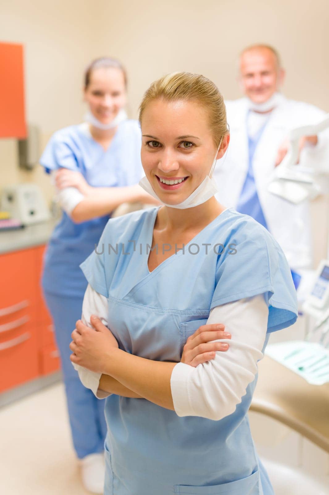 Portrait of dental team at modern surgery focus on nurse