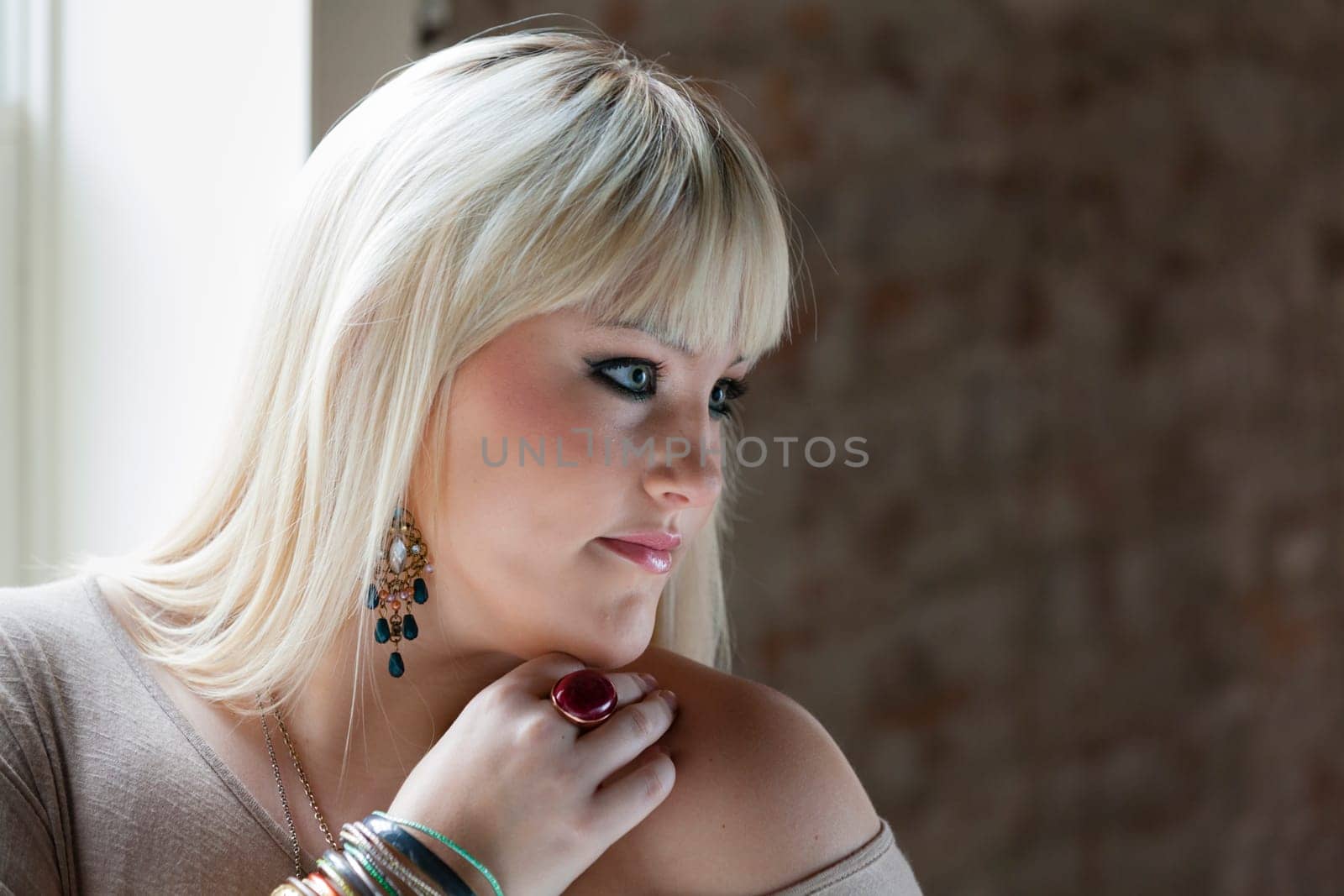 Attractive young woman standing by the window