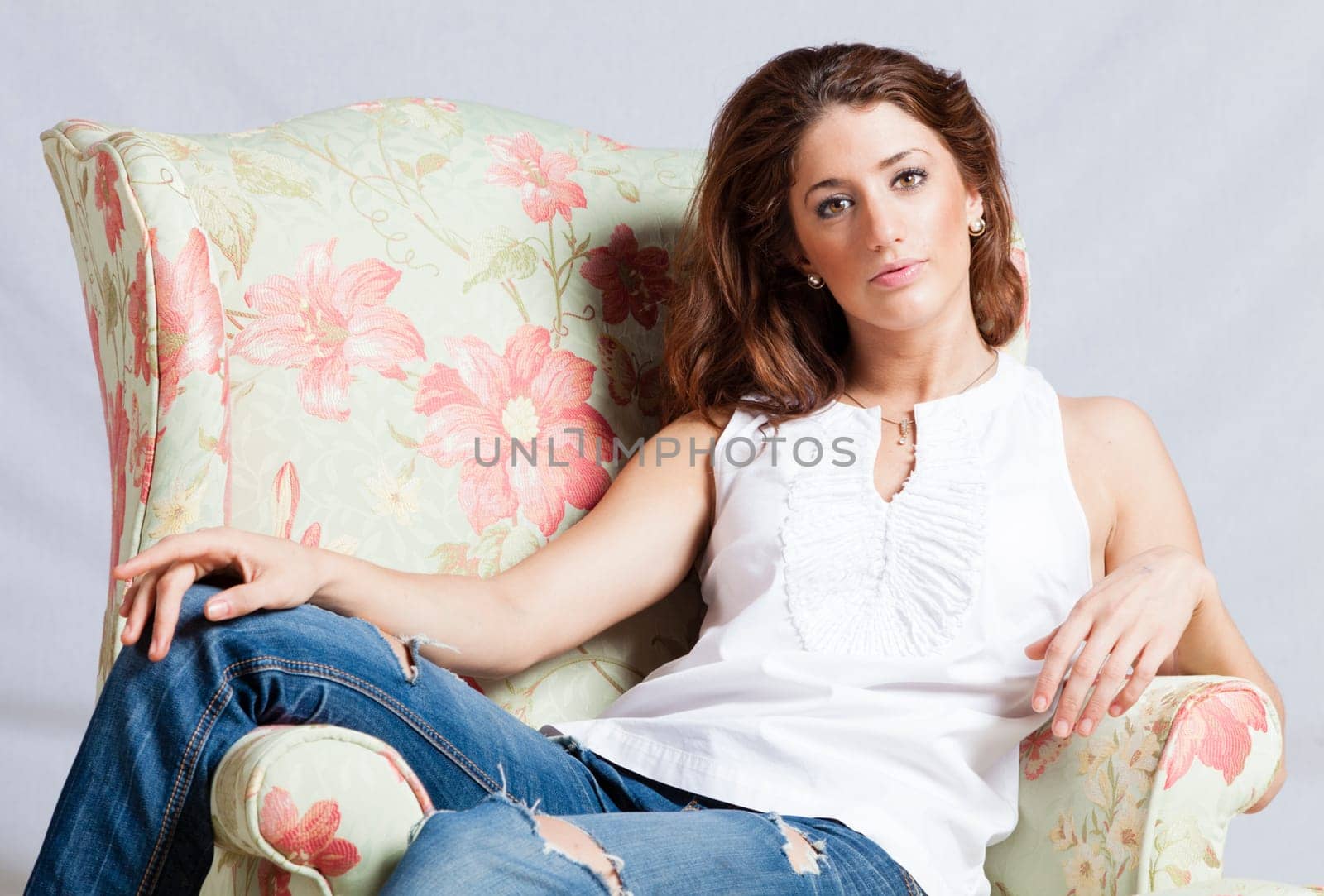 Portrait of a beautiful young woman relaxing in the armchair