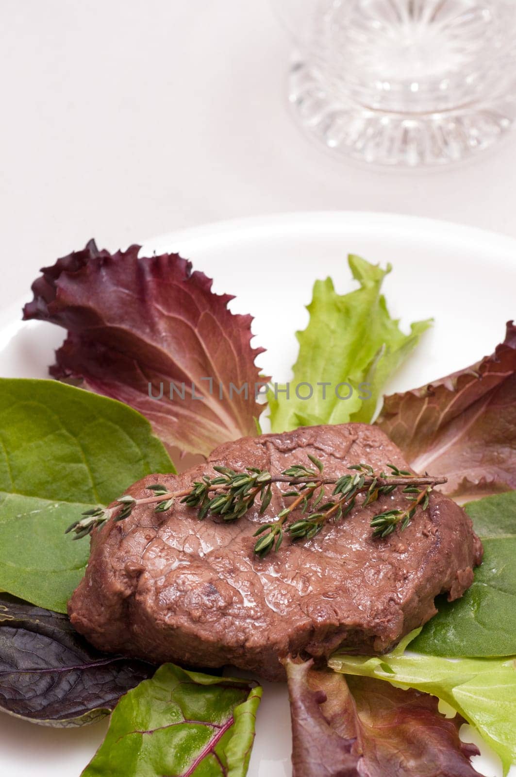 Beef steak with thyme on lettuce