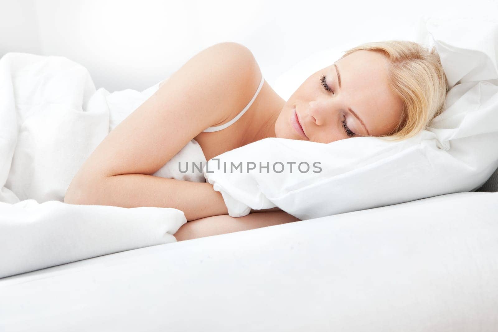 Young beautiful woman sleeping in bed at home
