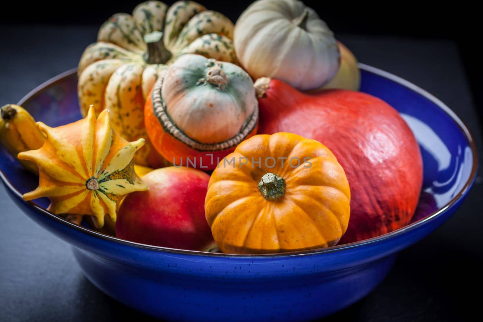 Pumpkins in the bowl on dark background