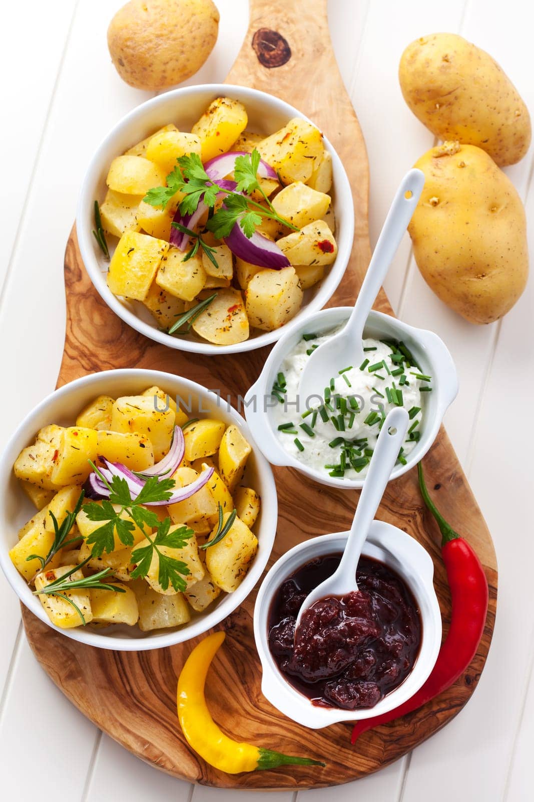 Baked potatoes with chutney and sour cream - top view