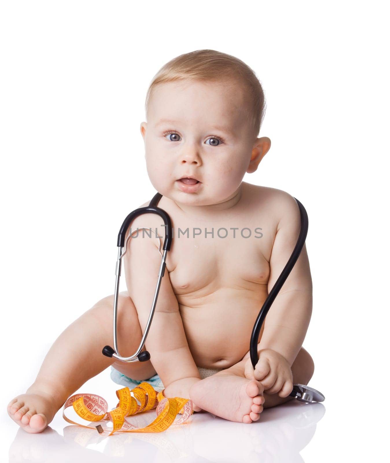 Sweet baby with stethoscope and measure tape on a white background. Adorable baby boy on white