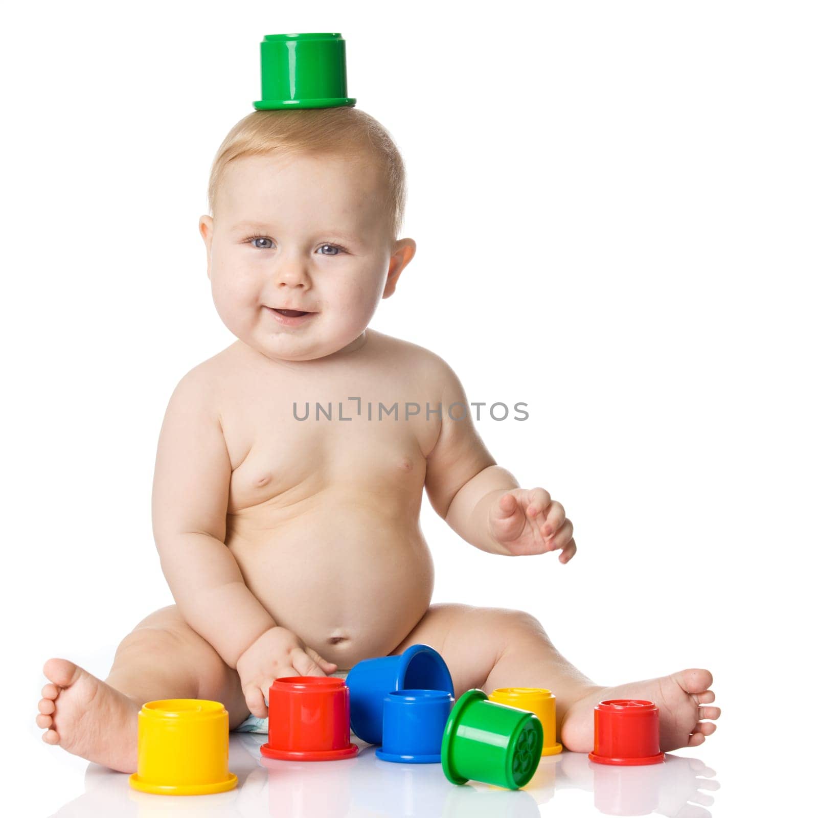 Baby playing with cup toys. Isolated on white background
