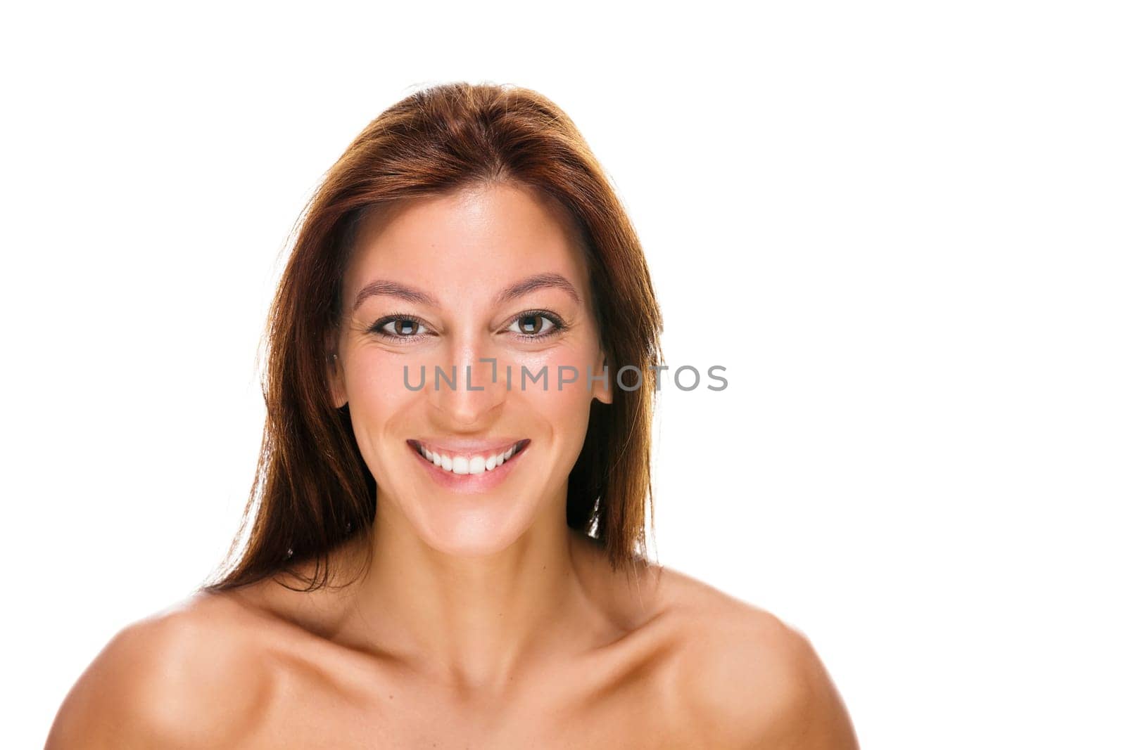 Portrait of a happy young woman against a white background