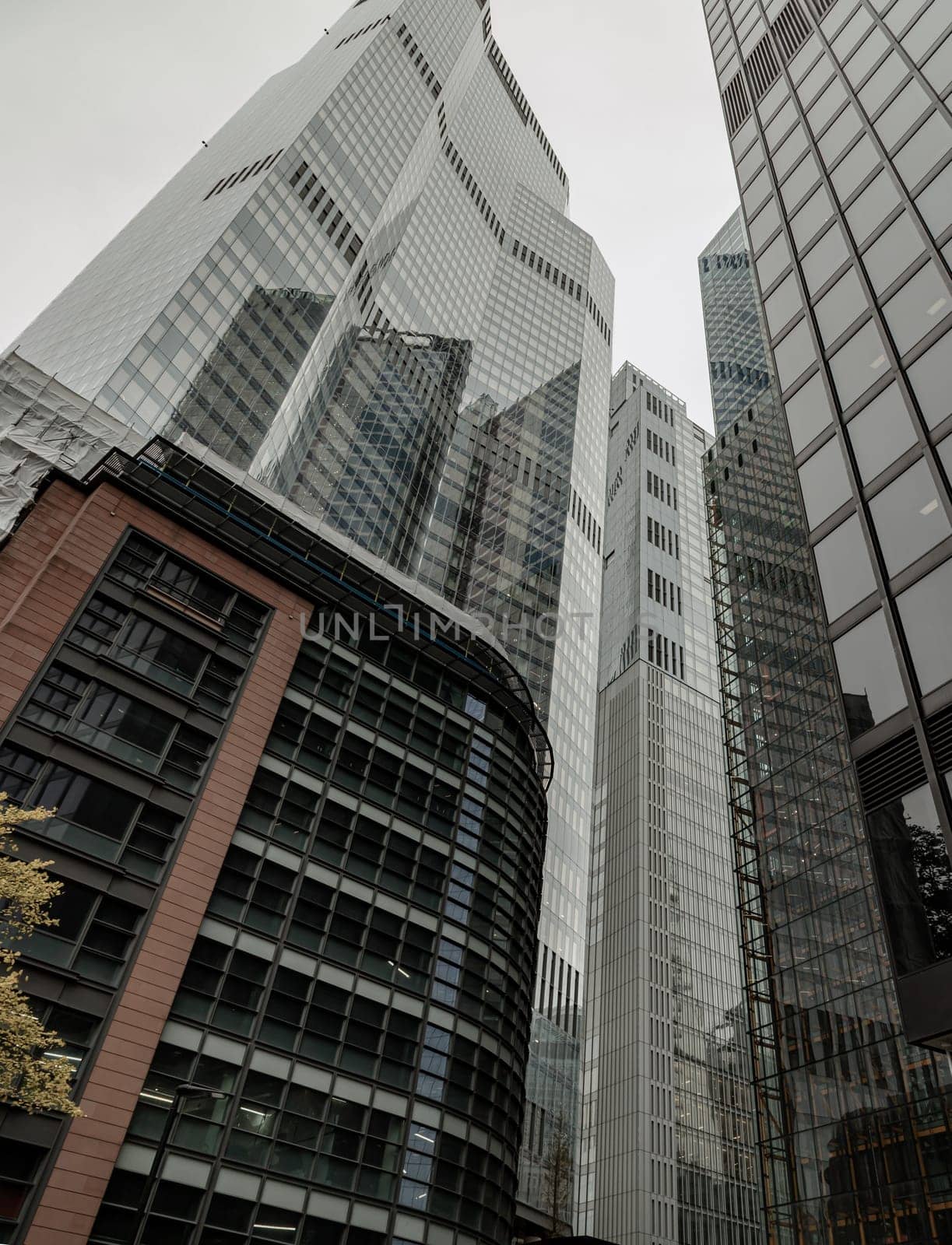 London, UK - Oct 23, 2023 - Looking up to highrise office build containing architecture modern design. View of the skyscraper from below, its ultra modern contemporary buildings with unique architecture, Space for text, Selective focus.