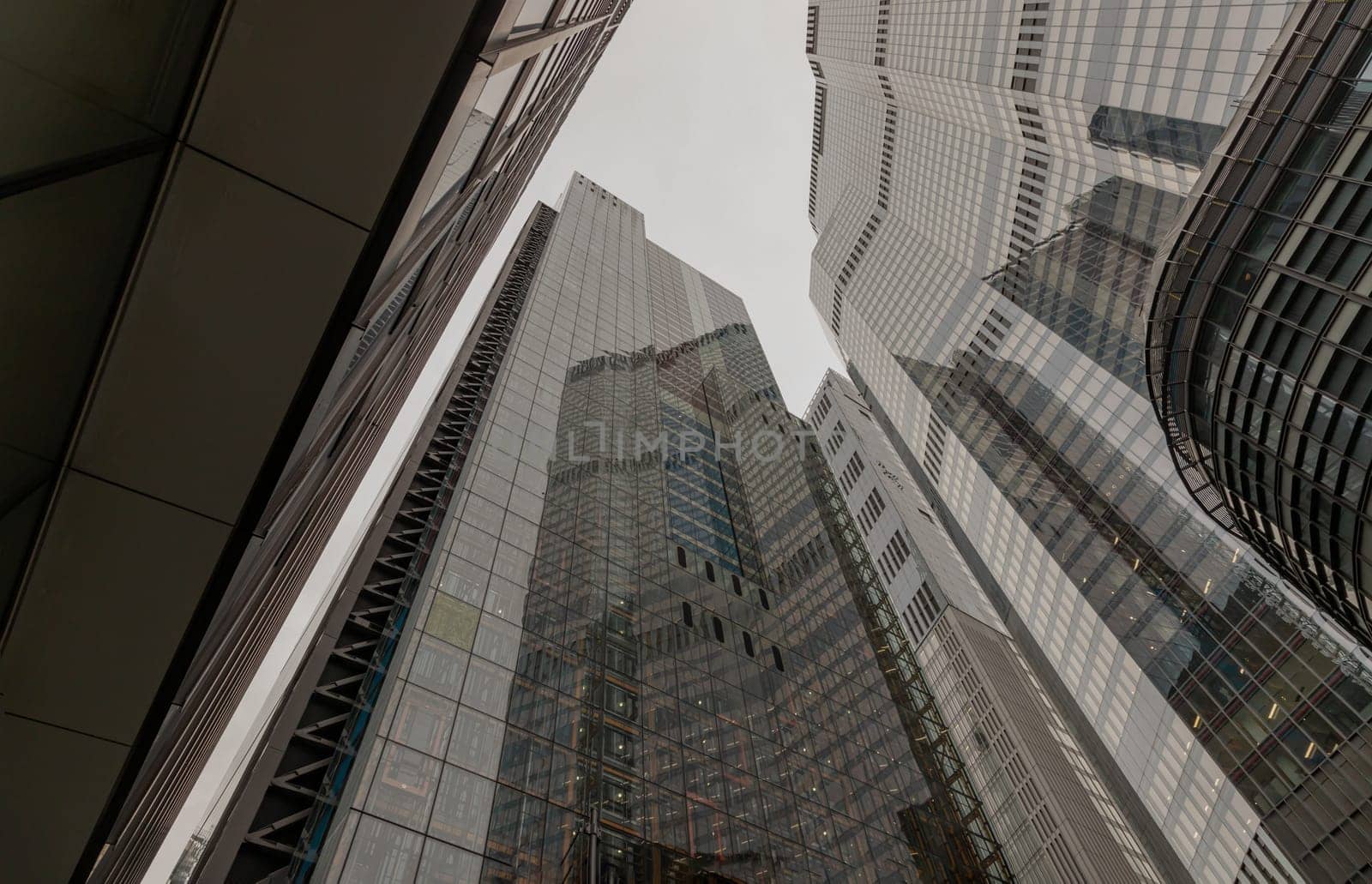 London, UK - Oct 23, 2023 - Looking up to highrise office build containing architecture modern design. View of the skyscraper from below, its ultra modern contemporary buildings with unique architecture, Space for text, Selective focus.