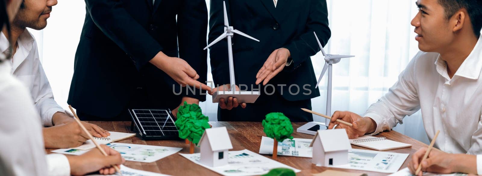 Green energy business company meeting with business people planning and discuss marketing of sustainable and renewable clean energy product with solar cell and wind turbine generator. Trailblazing