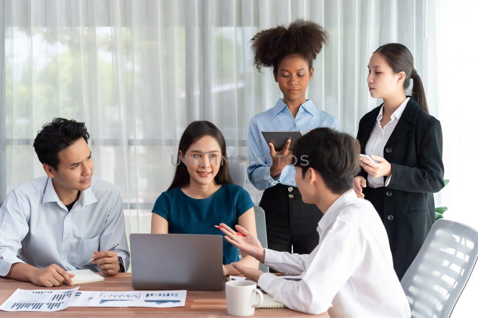 Multiracial analyst team use BI dashboard data to analyze financial report on meeting table. Group of diverse business people utilize data analysis by FIntech for success business marketing. Concord