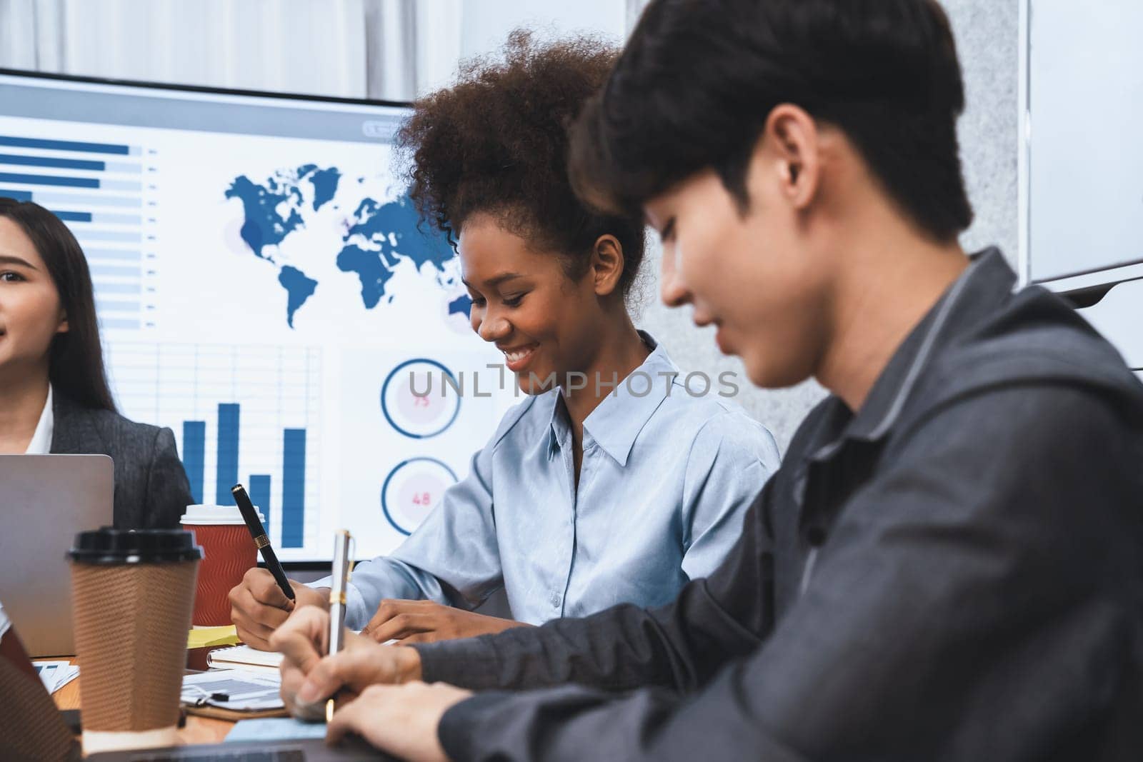 Multiracial analyst team use BI dashboard data to analyze financial report on meeting table. Group of diverse business people utilize data analysis by FIntech for business marketing decision. Concord