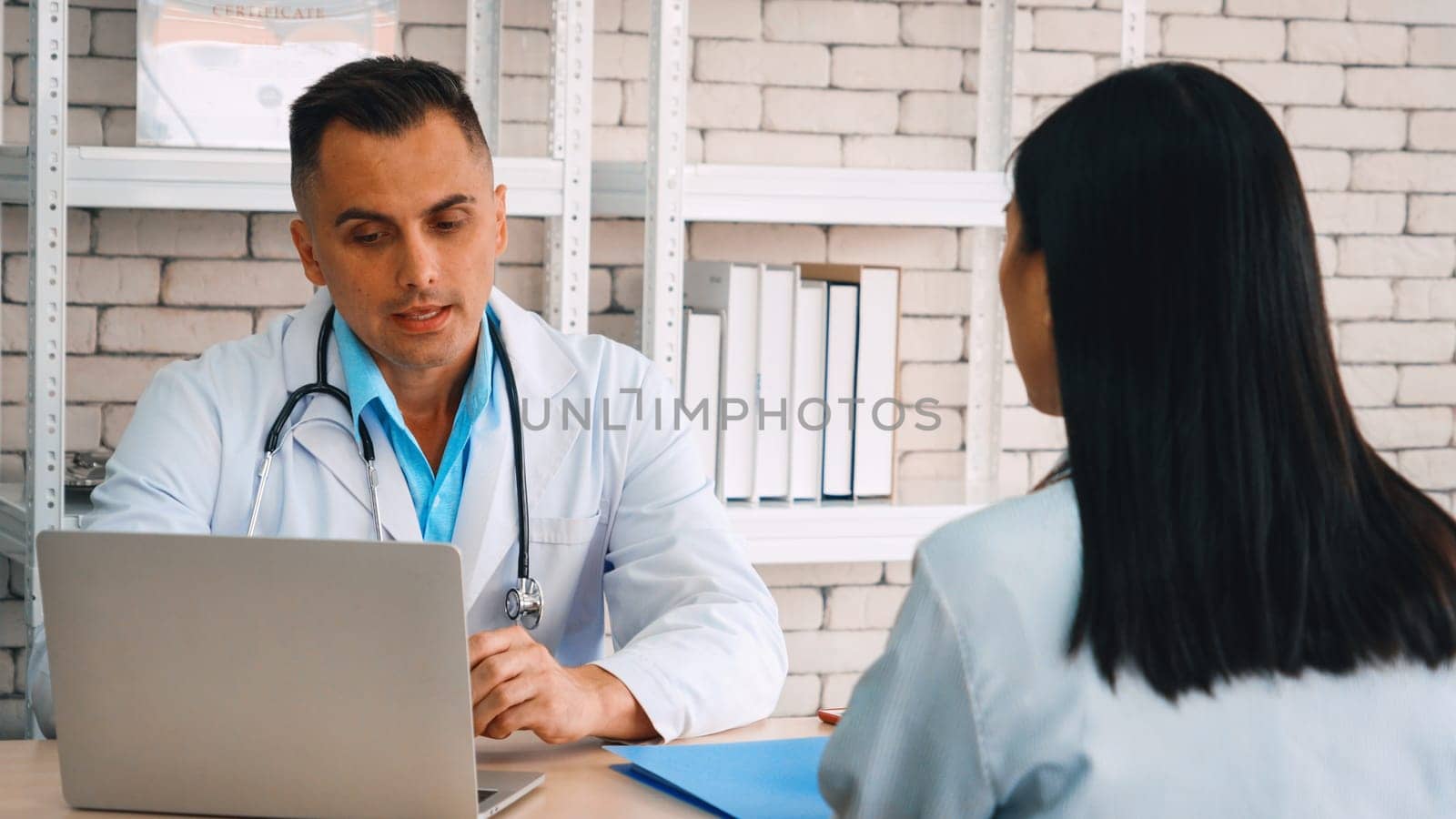 Doctor in professional uniform examining patient at hospital or medical clinic. Health care , medical and doctor staff service concept. Jivy