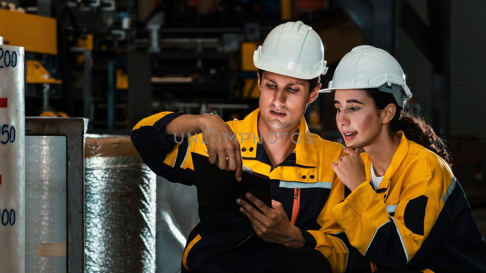 Two factory workers or engineers conduct professional inspection on machine or procedure in chemical plant, chemistry factory workplace and industrial profession concept. Exemplifying