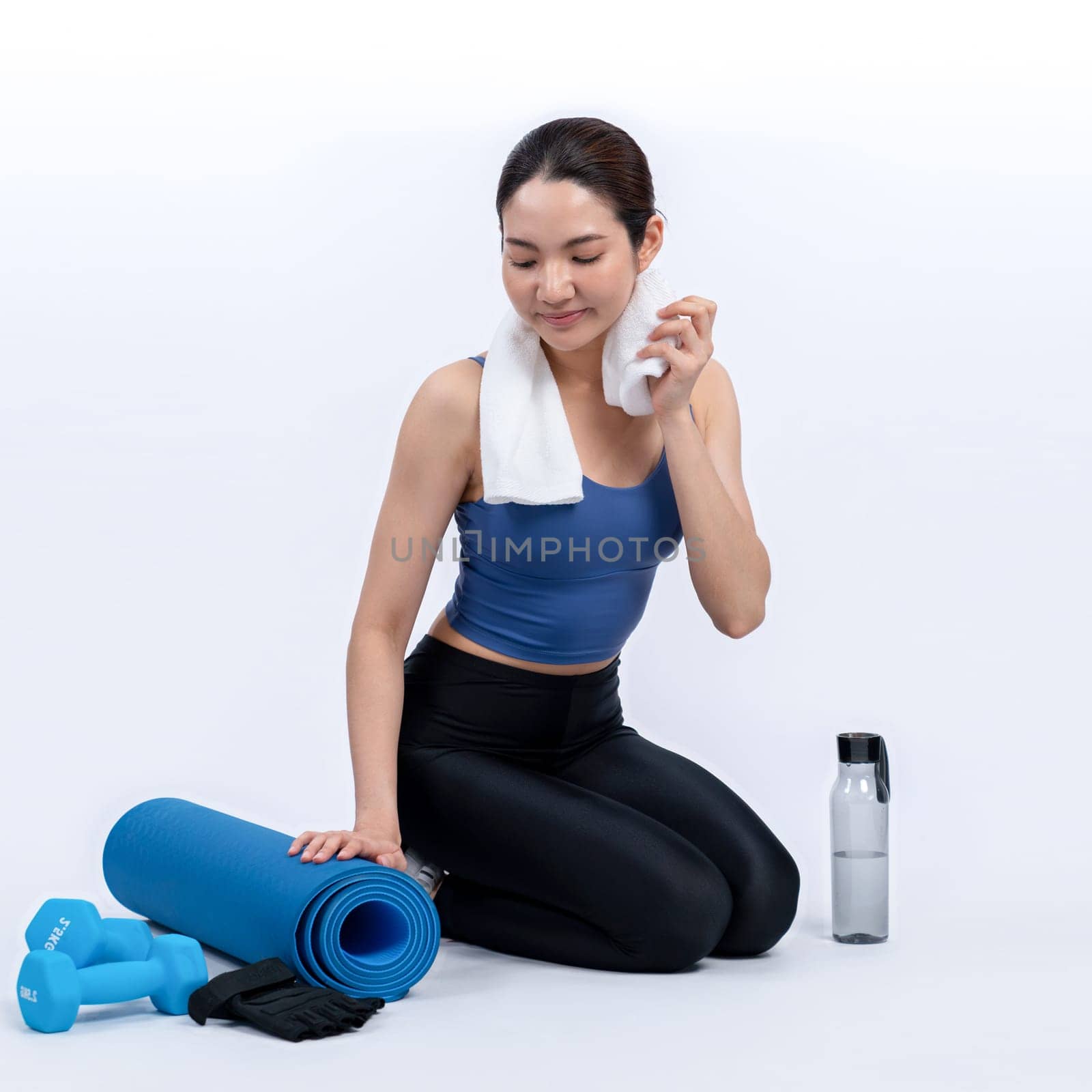 Athletic and sporty asian woman resting after intensive cardio workout training. Healthy exercising and fit body care lifestyle pursuit in studio shot isolated background. Vigorous