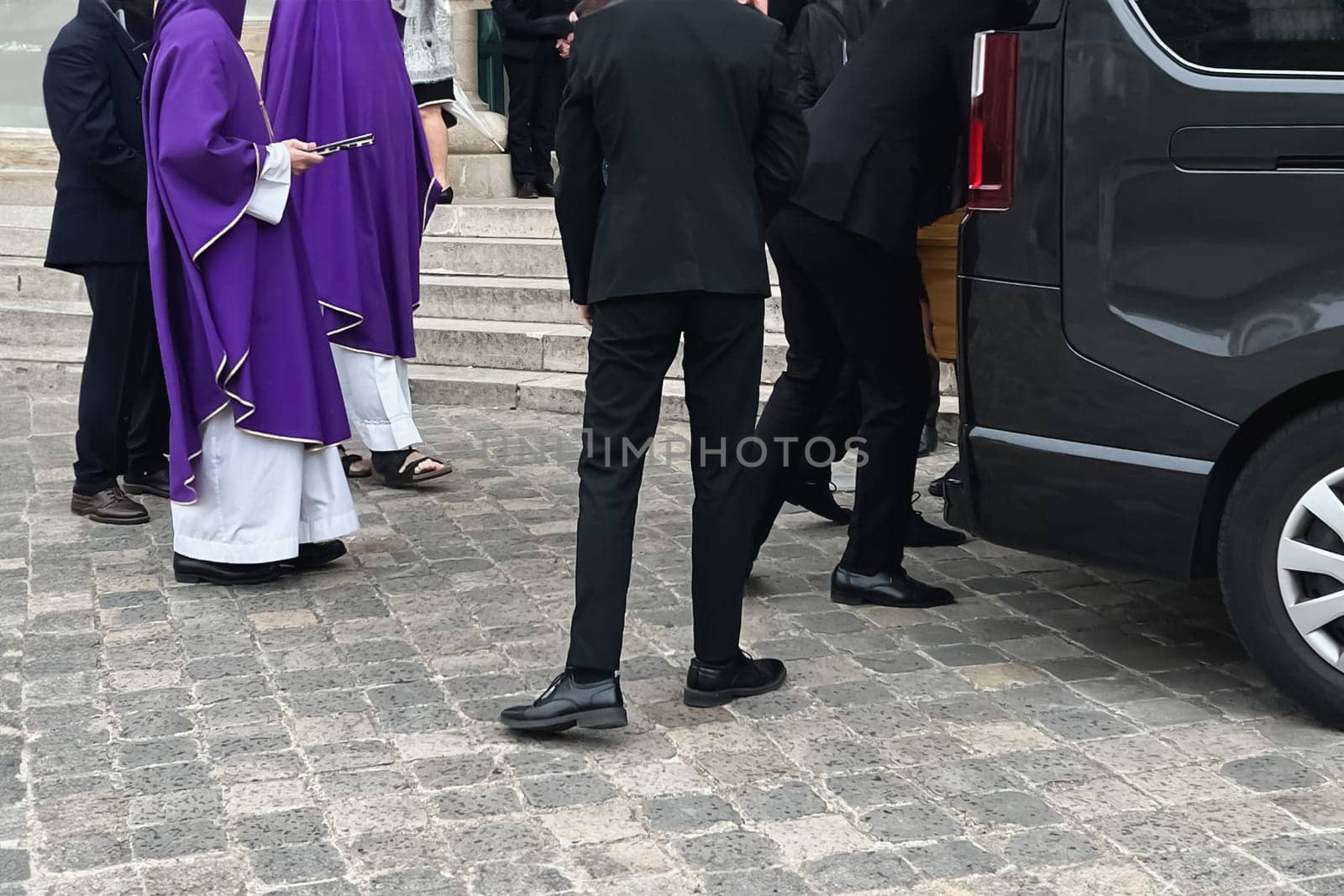Funeral service loading the coffin into the hearse