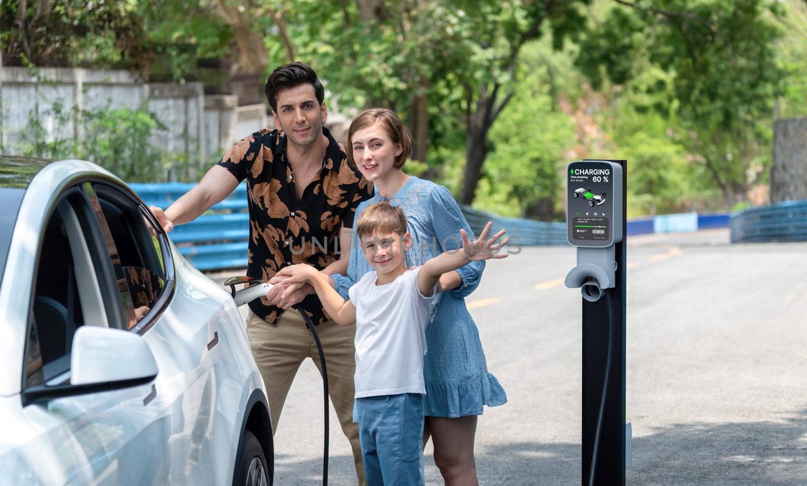 Family road trip vacation with electric vehicle, lovely family recharge EV car with green and clean energy. Natural and eco friendly car travel for sustainable environment. Perpetual