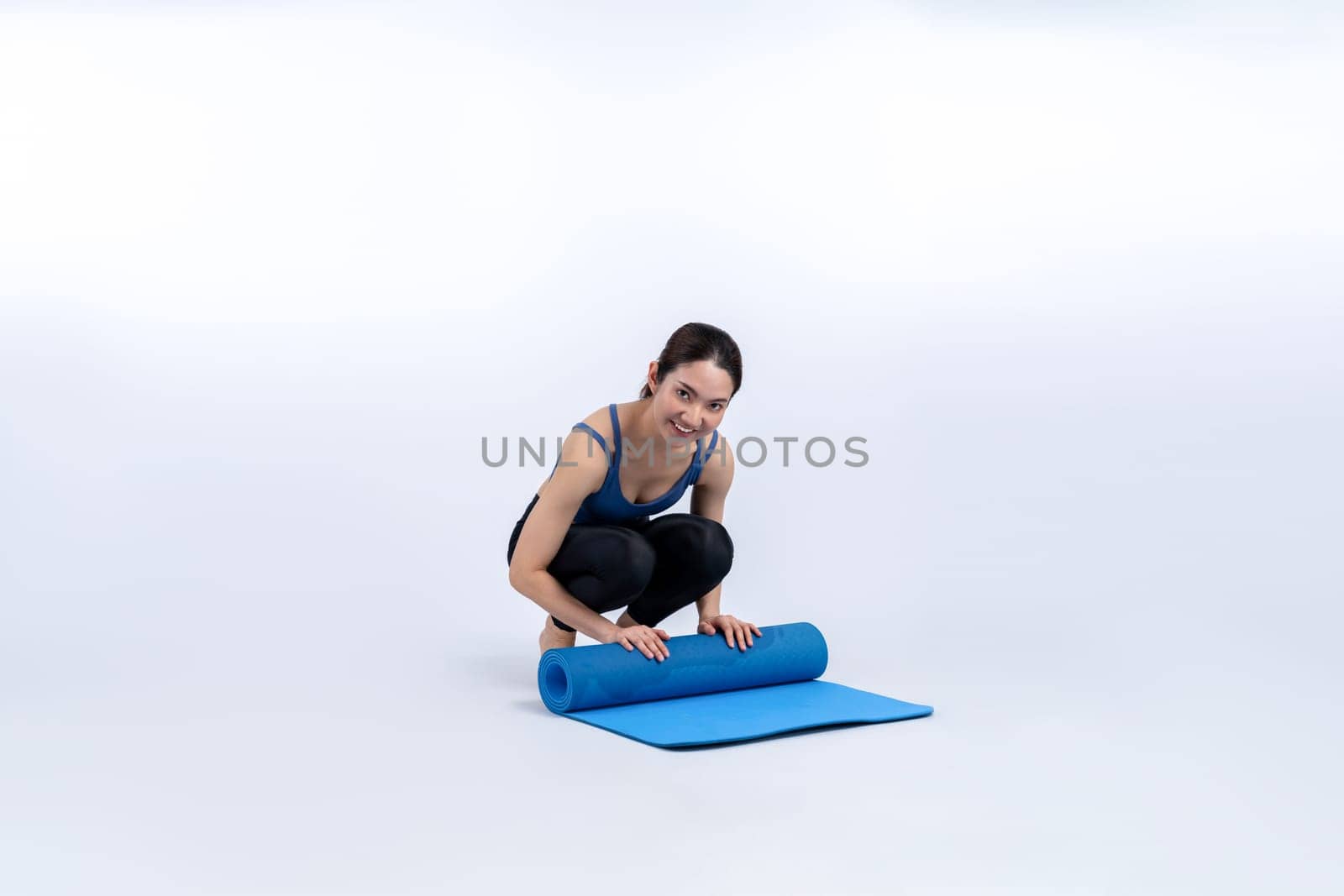 Young attractive asian woman portrait in sportswear with exercising mat. Healthy exercise and workout routine lifestyle concept. Studio shot isolated background. Vigorous