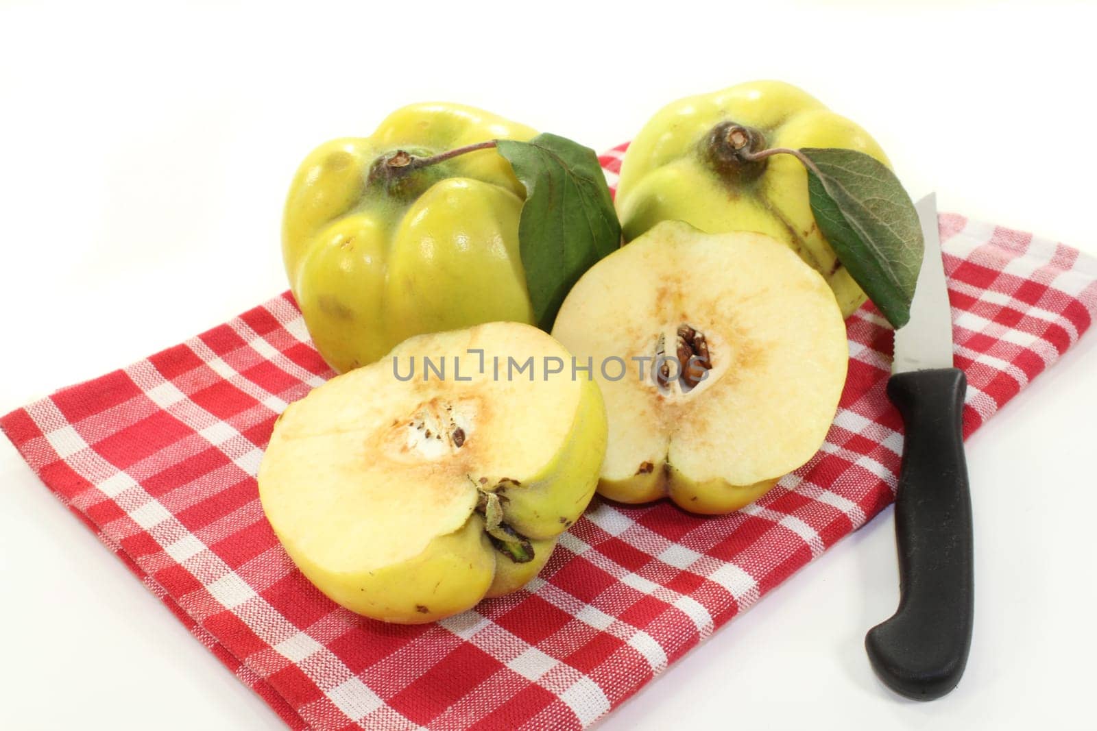 Three quinces against white background