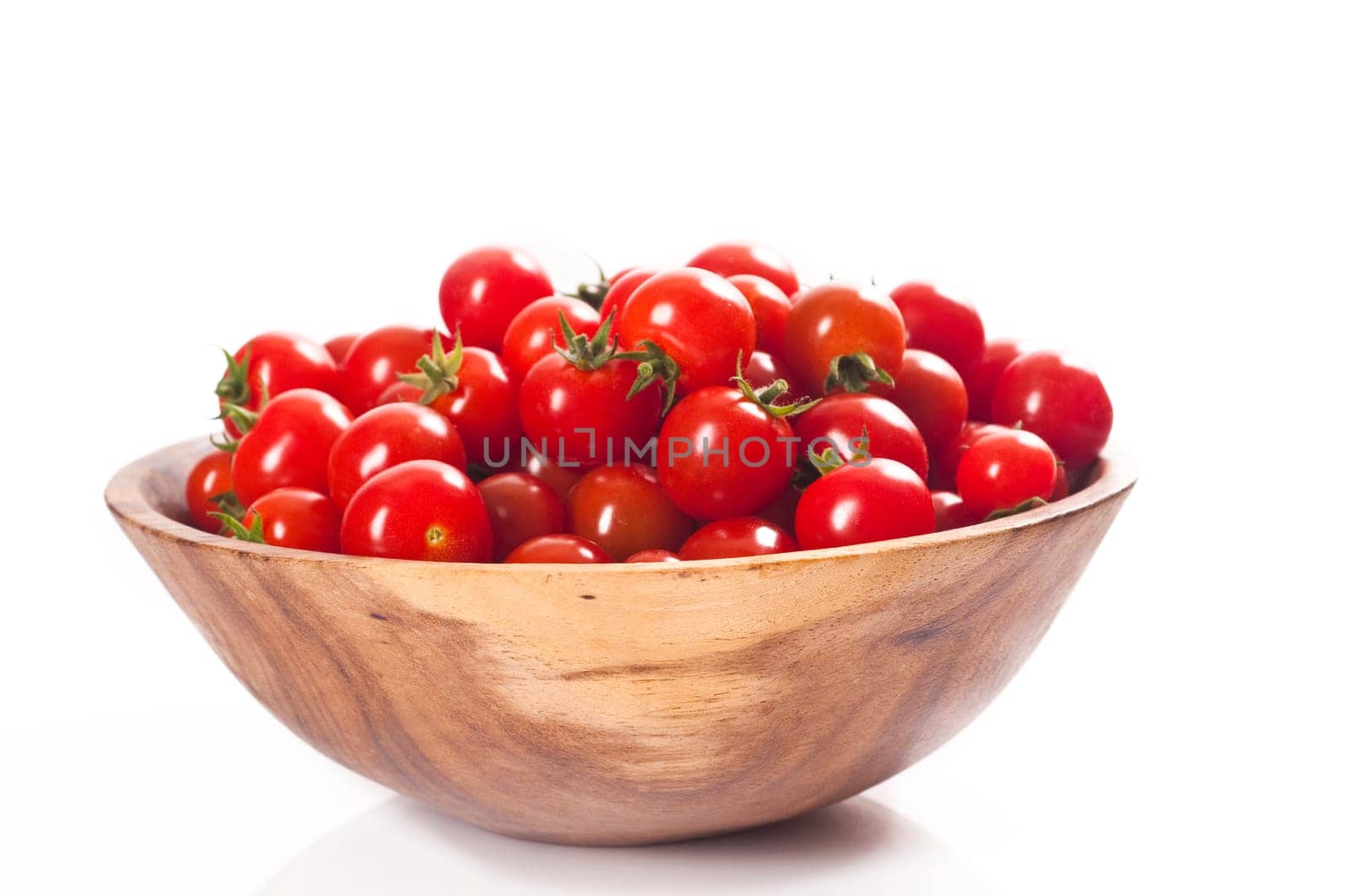 fresh cherry tomatoes in wooden bowl