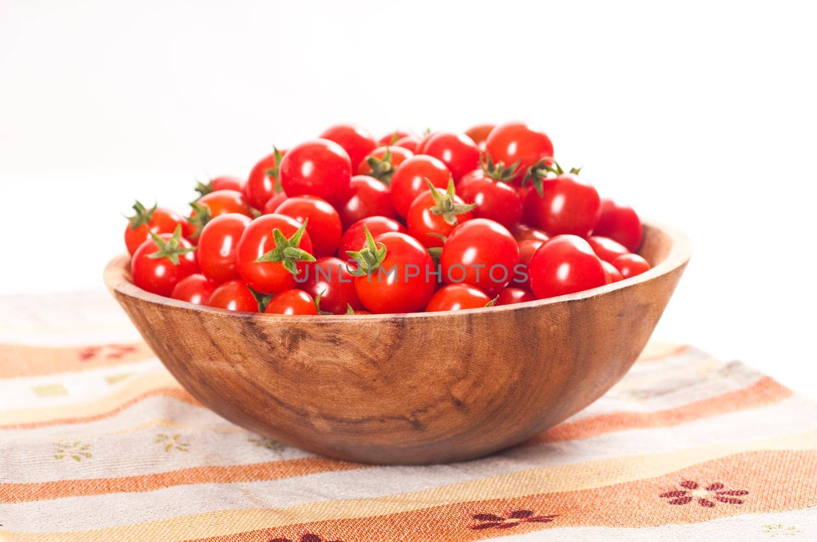 fresh cherry tomatoes in wooden bowl