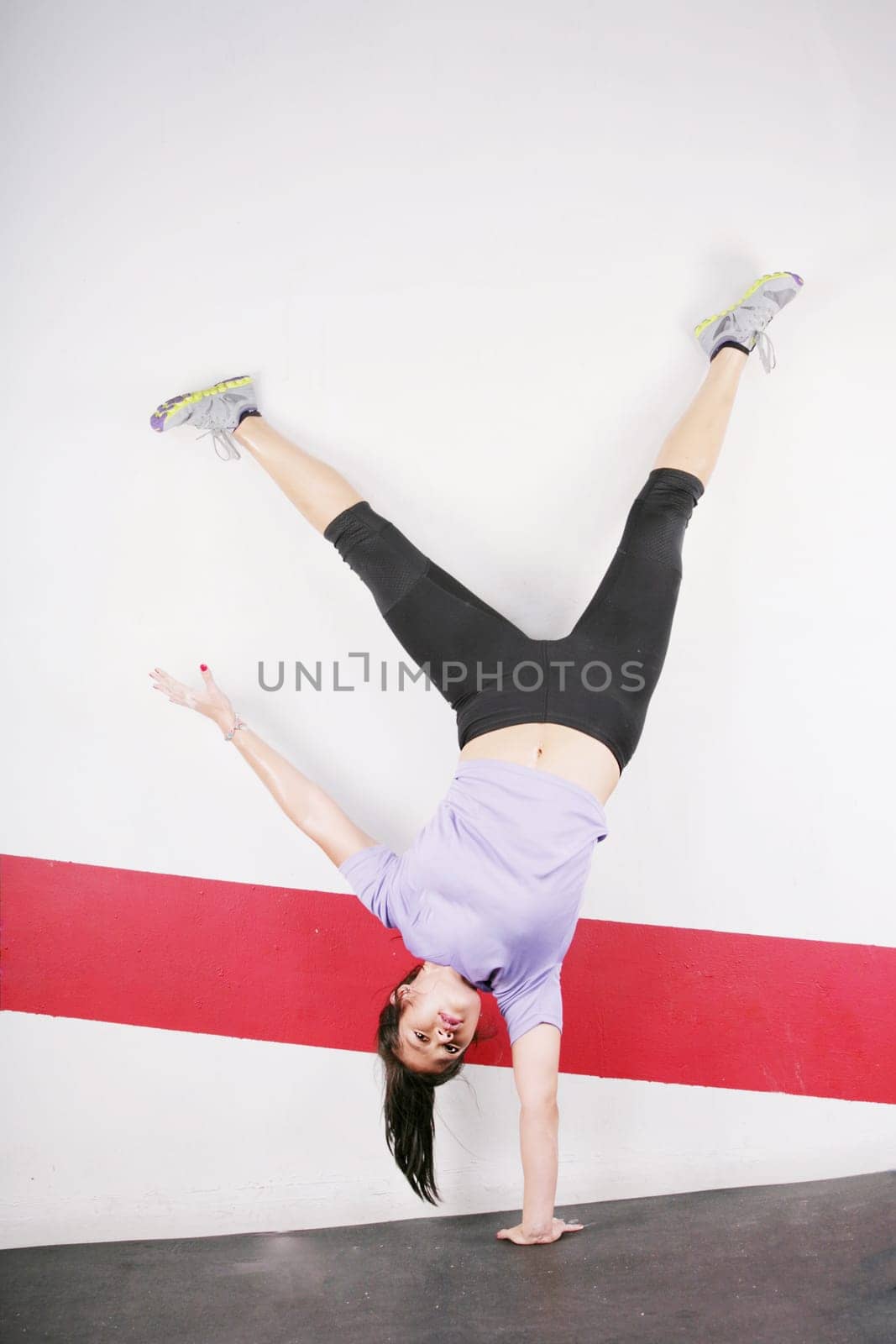 flexible girl standing on one hand