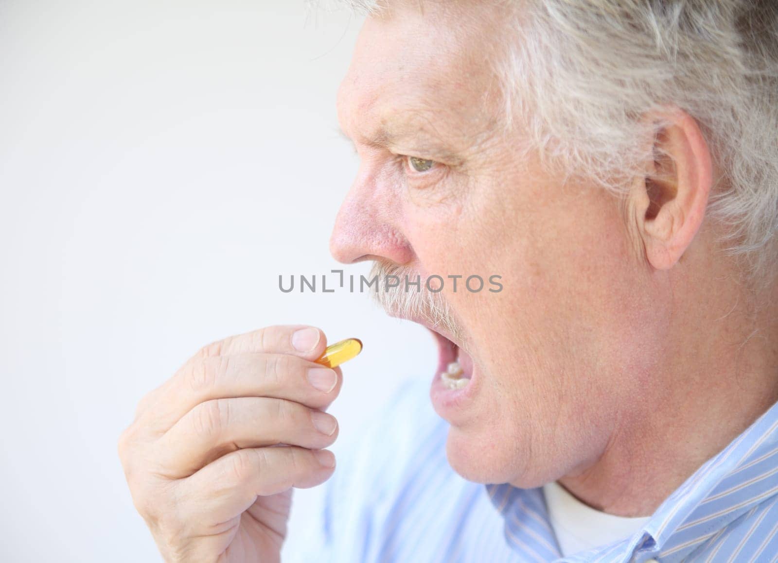 senior takes fish oil supplement