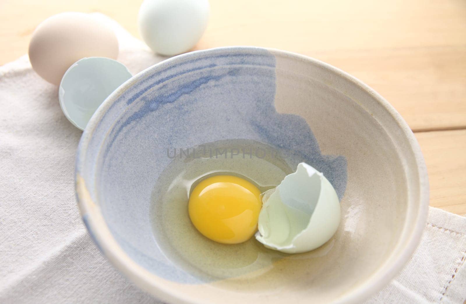 broken Araucana egg in a decorative bowl