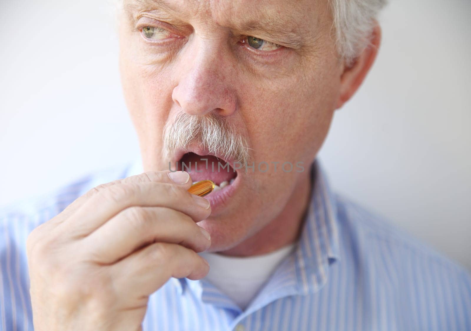 man taking fish oil pill