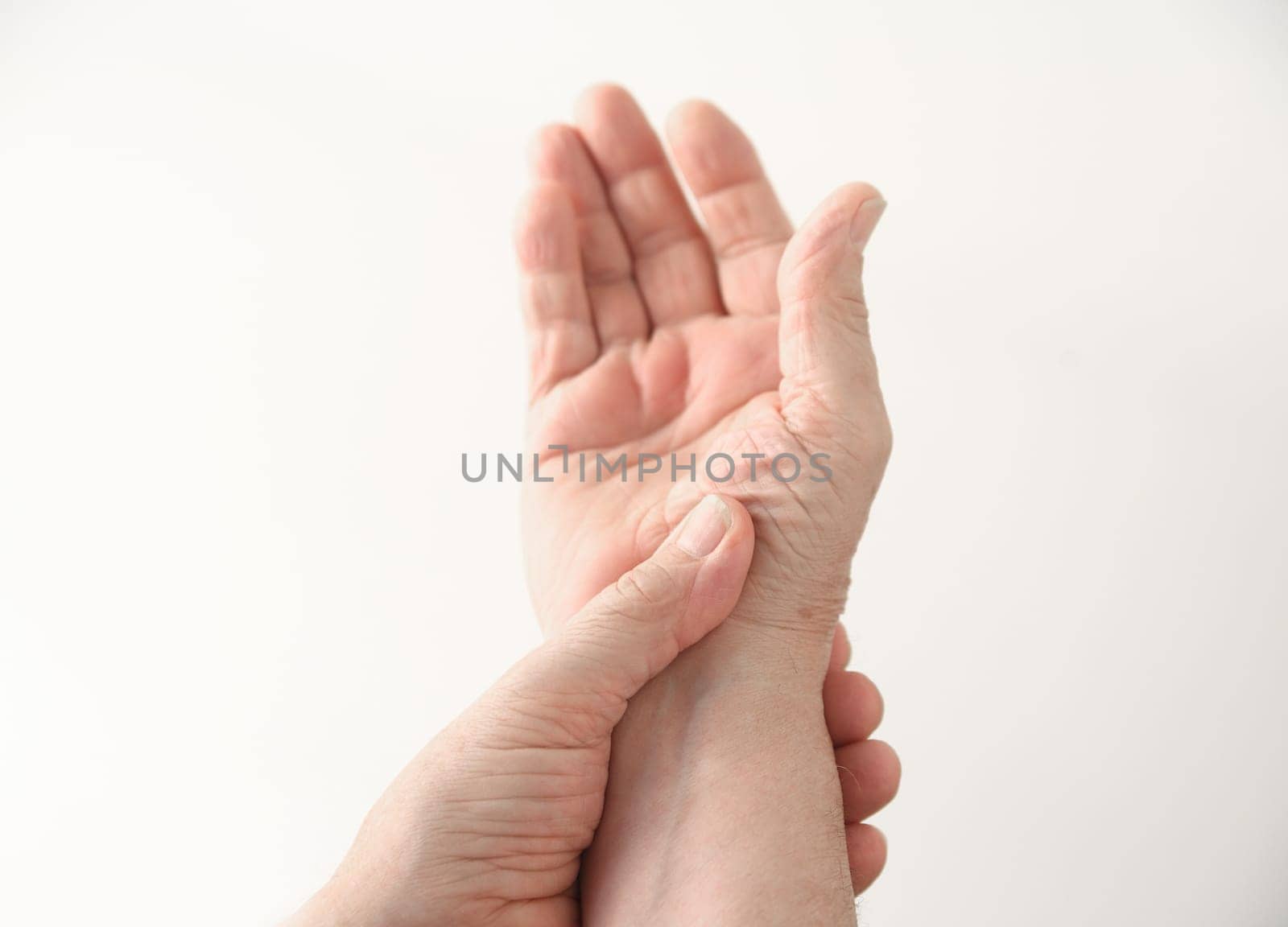 a man with pain at the base of his thumb