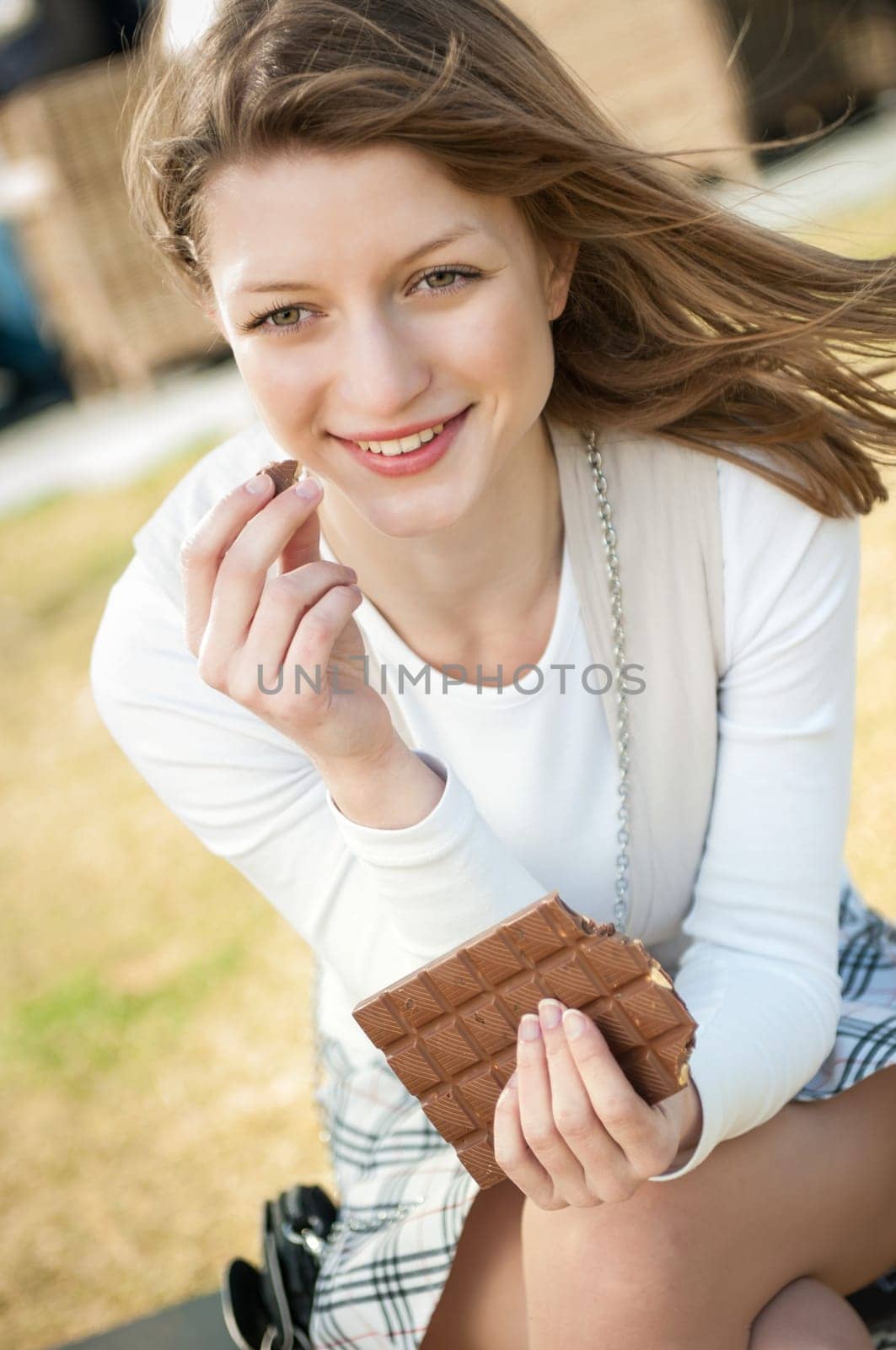Lifestyle outdoor Young beautiful woman eating chocolate - lifestyle outdoor image