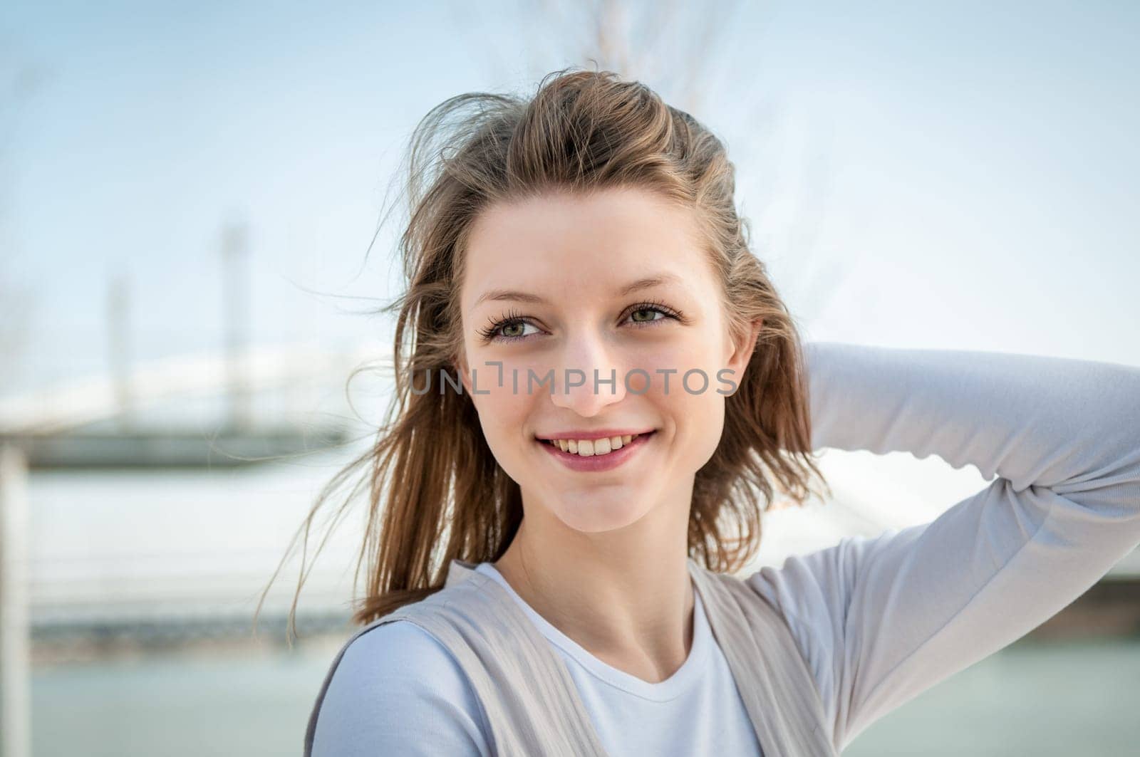 Outdoor portrait of young beautiful woman - hand in hair