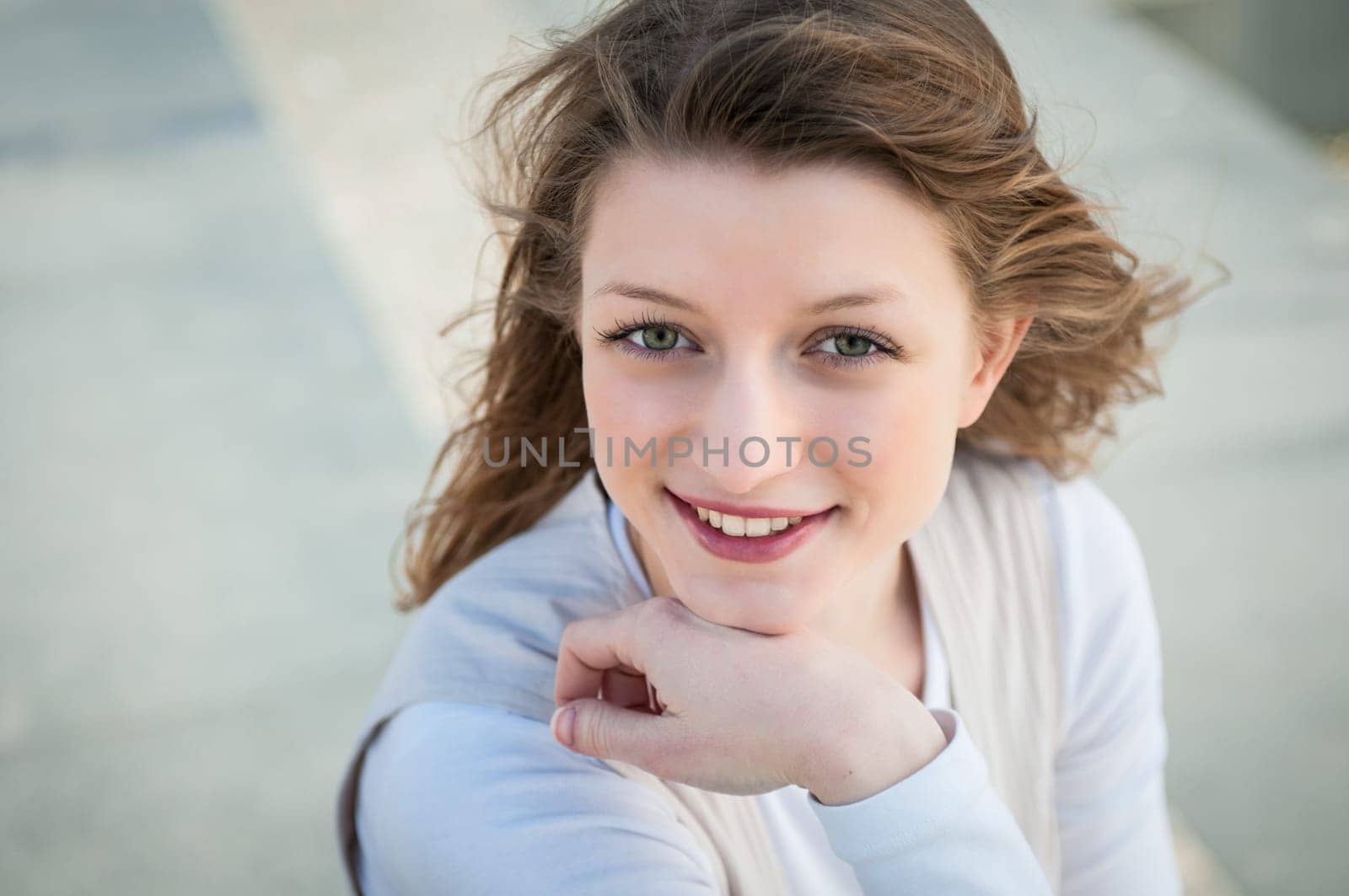 Portrait of young smiling woman - grey background
