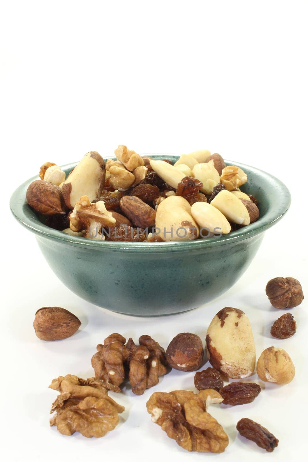 Various nuts and raisins against white background